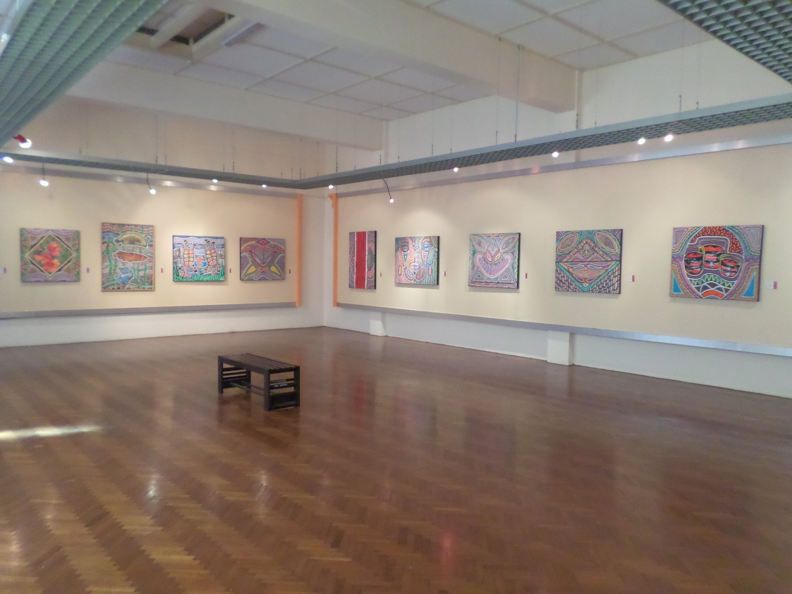A modern art gallery hung with colourful works.