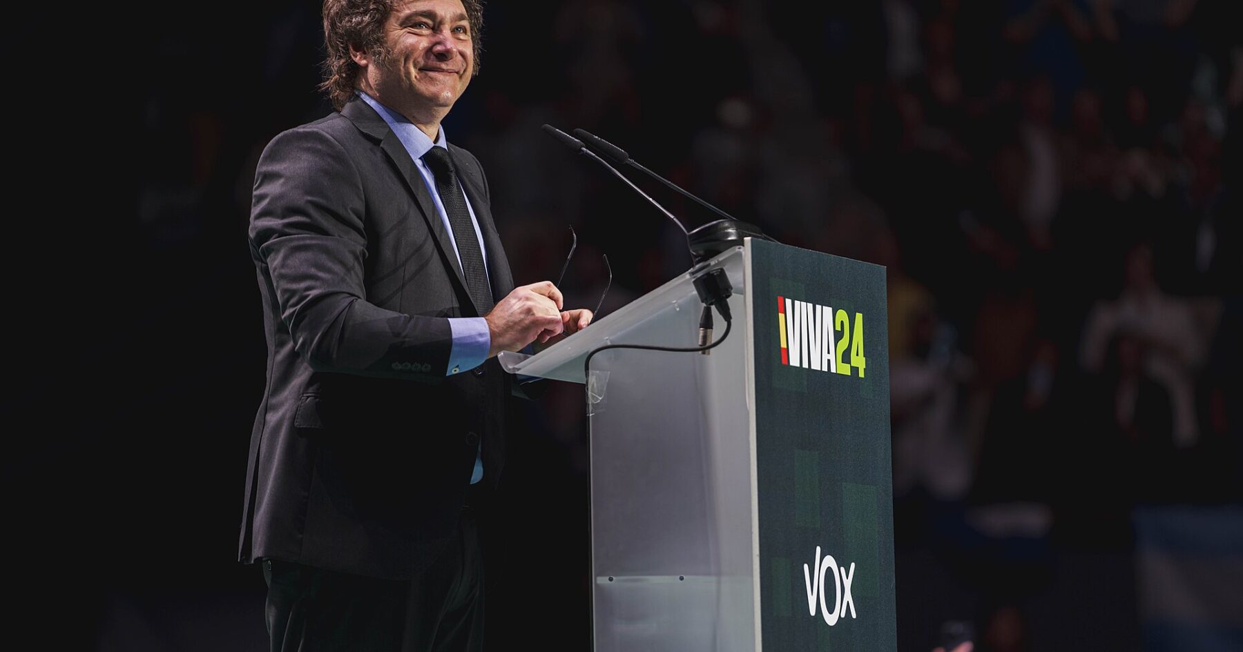 Javier Milei speaking at a podium with Argentine flag, illustrating Milei youth support decline.