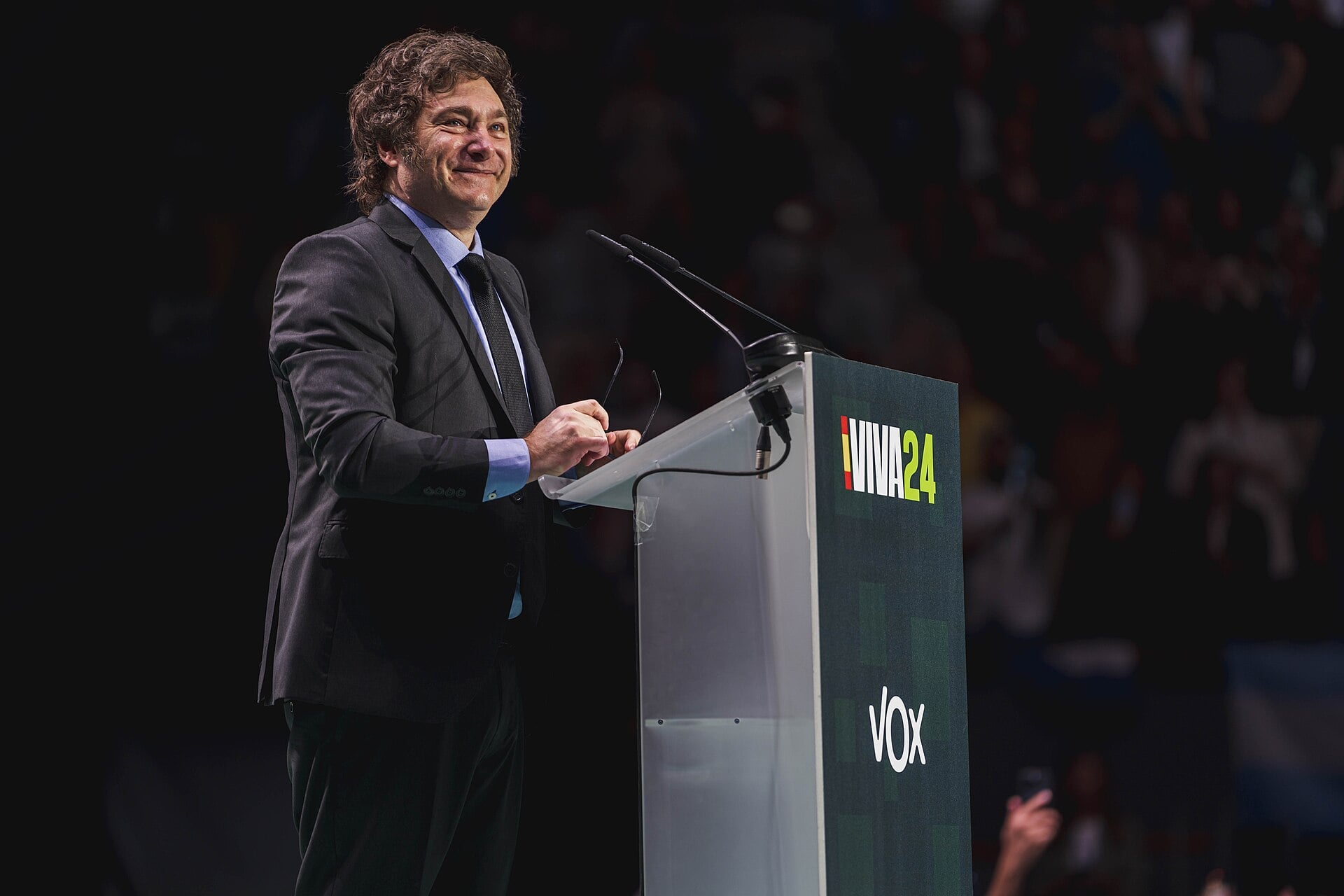 Javier Milei speaking at a podium with Argentine flag, illustrating Milei youth support decline.