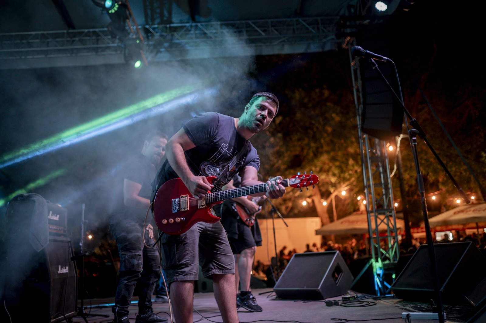 A band performs on a blue-lit stage.
