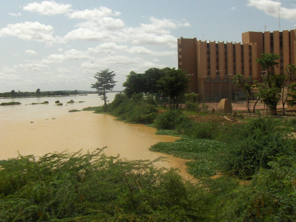 The Niger River at Niamey with a large public building on the bank