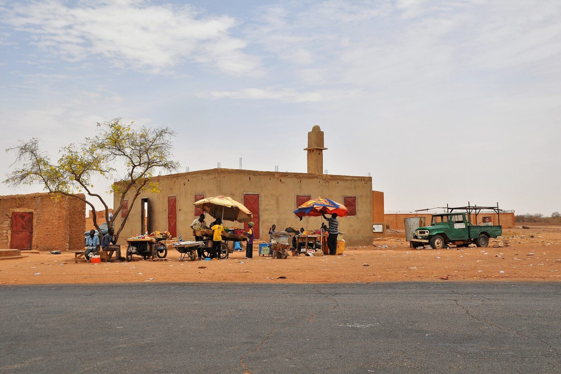 Niger plastic bag ban - roadside market stalls and scattered litter in Koure, Niger