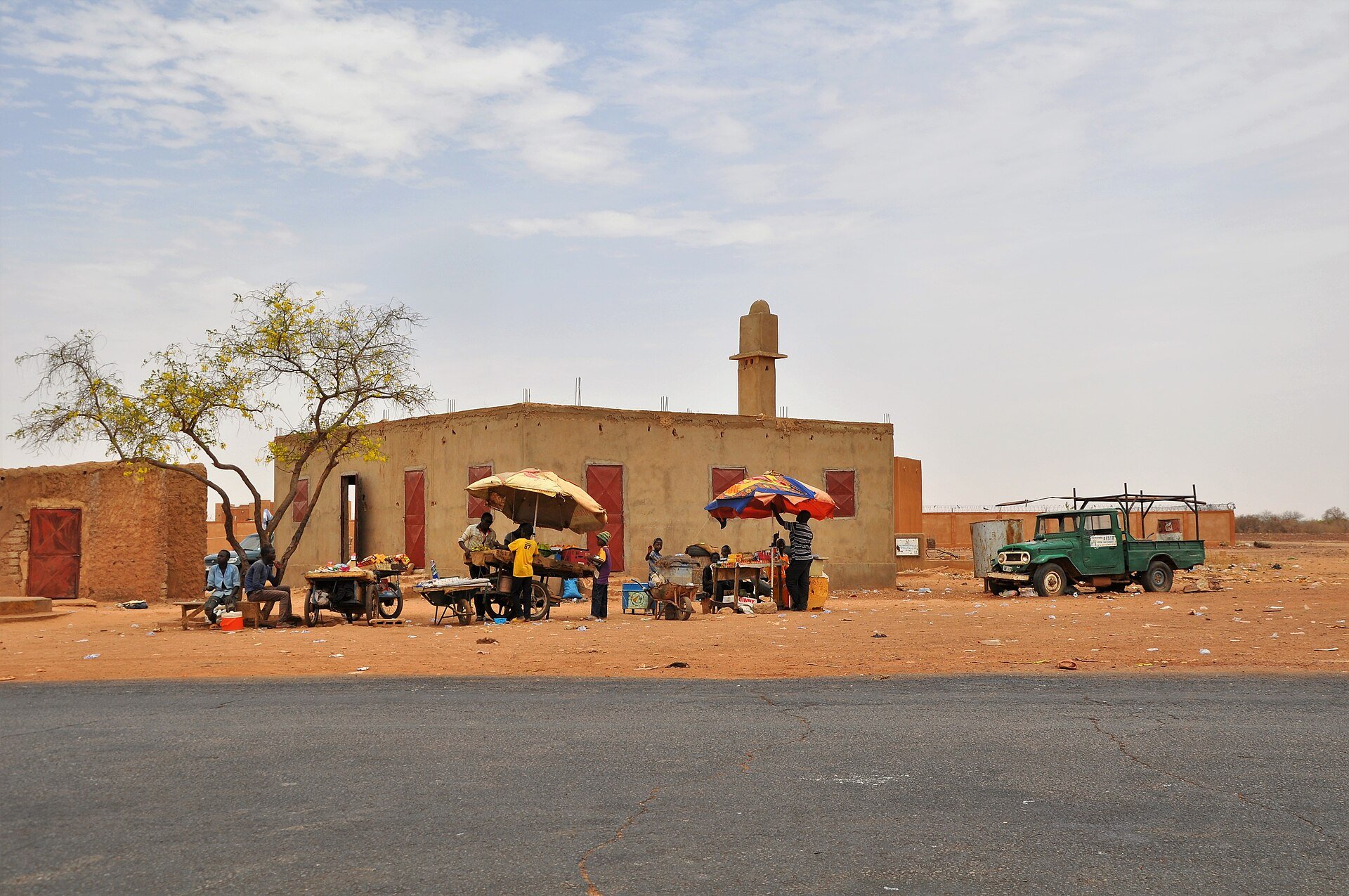Niger plastic bag ban - roadside market stalls and scattered litter in Koure, Niger