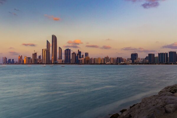 The Abu Dhabi skyline at dusk seen across the water, illustrating Nigeria's US$5 billion facility