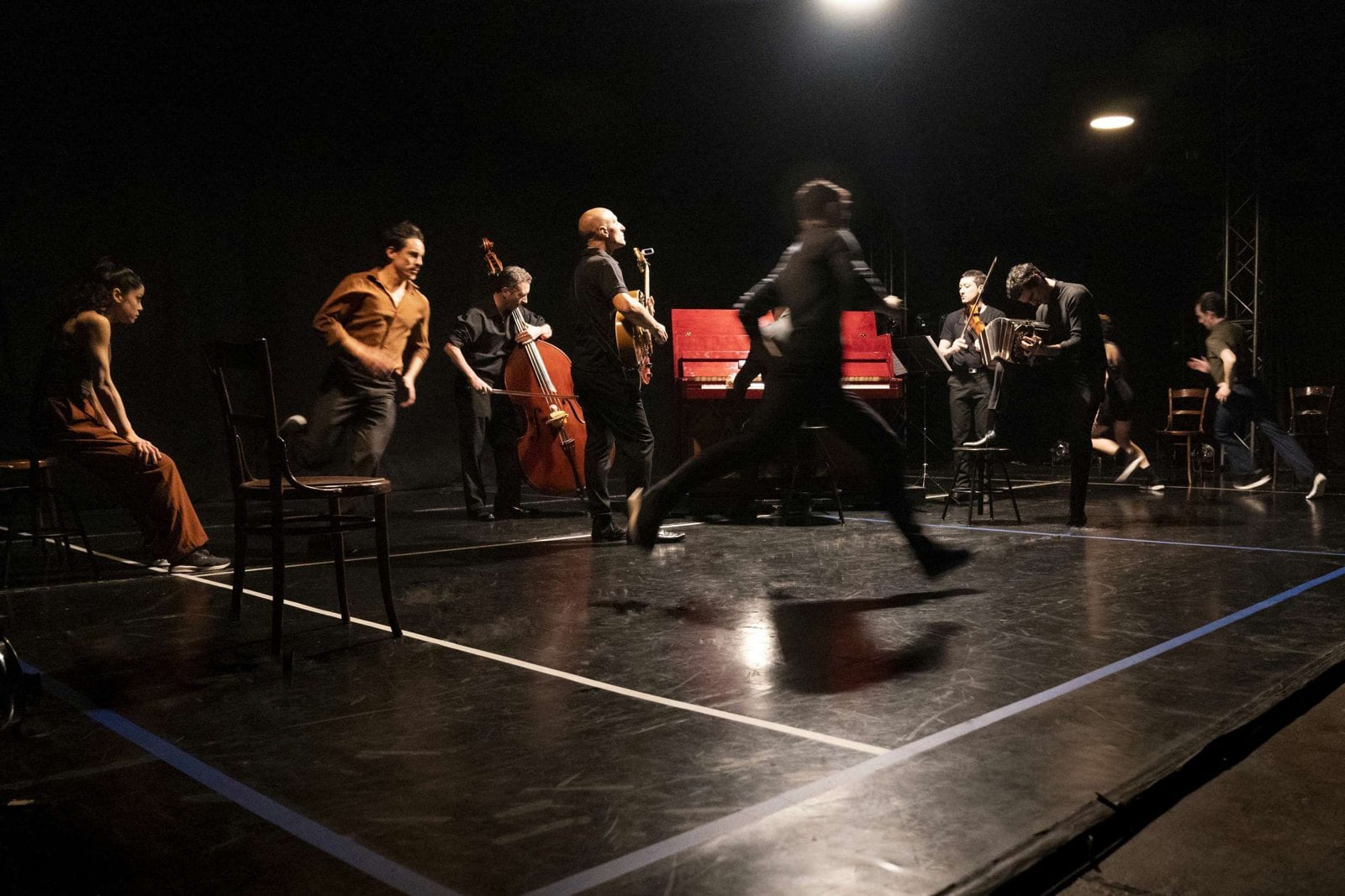 Musicians move among the dancers in a Noestango performance, dissolving the usual separation between orchestra and stage.