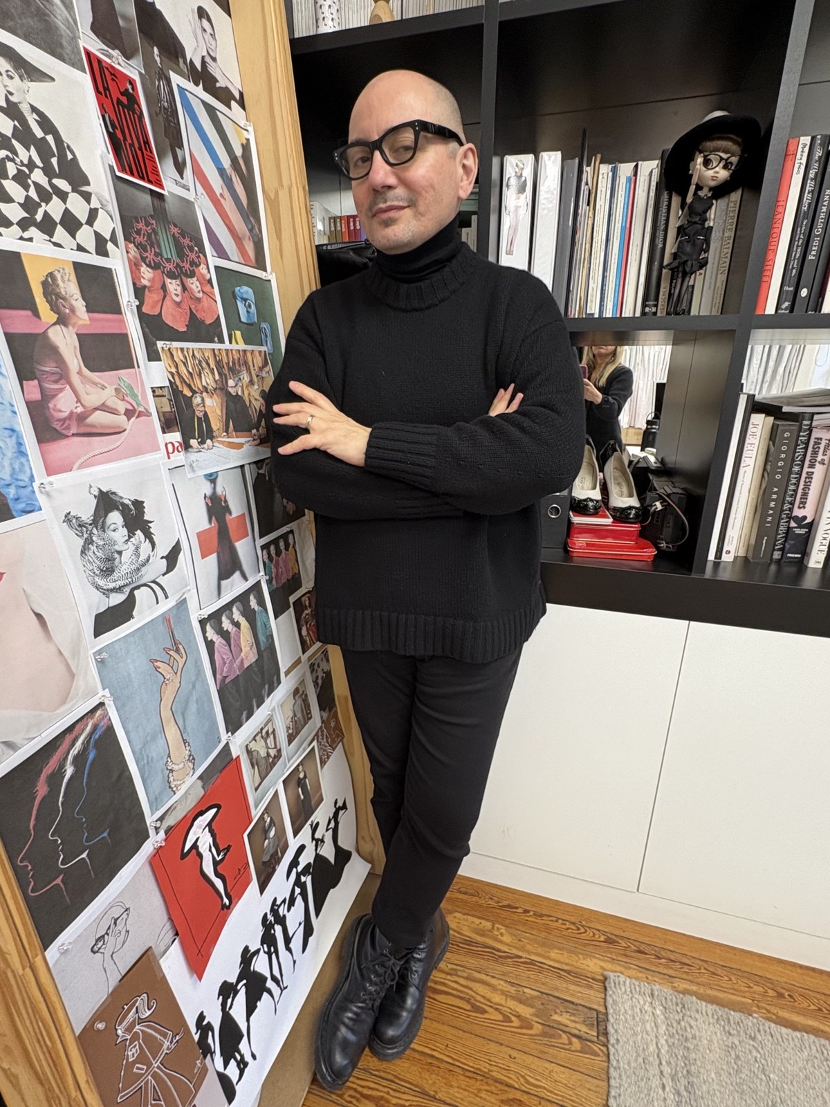 Pablo Ramirez beside the reference wall in his studio