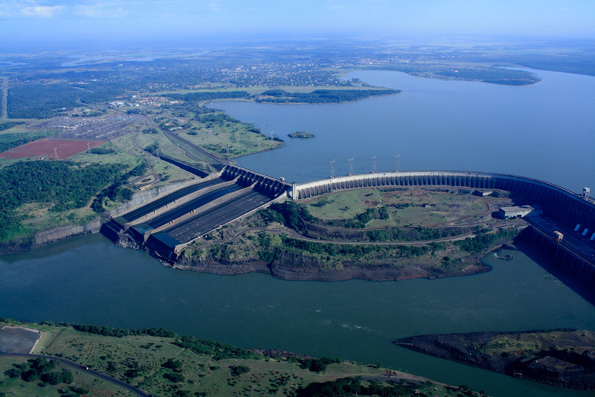 Paraguay bitcoin — Aerial view of a large bitcoin mining facility in Paraguay with shipping containers of mining rigs, near the Itaipú dam reservoir