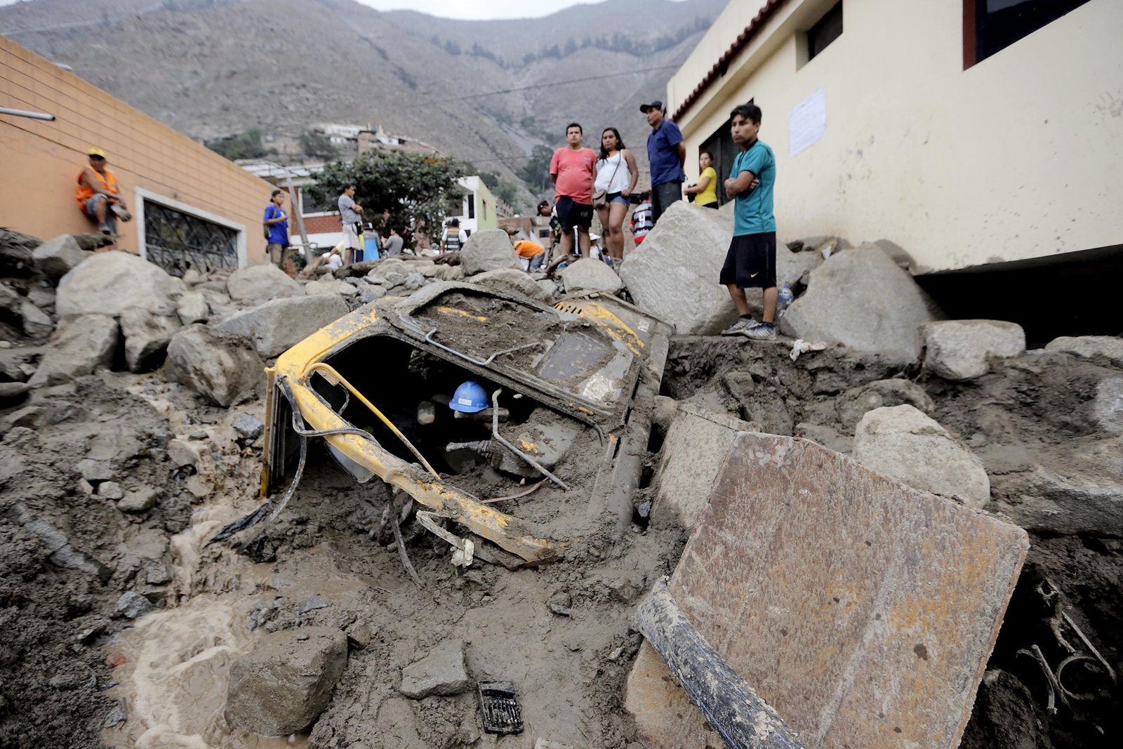 Peru El Niño — a car buried by a mudslide in Chosica, east of Lima