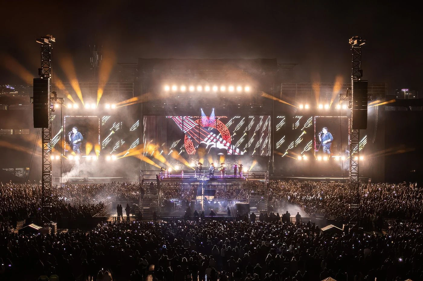 A packed night-time stadium concert of the kind that raised the Karol G donation