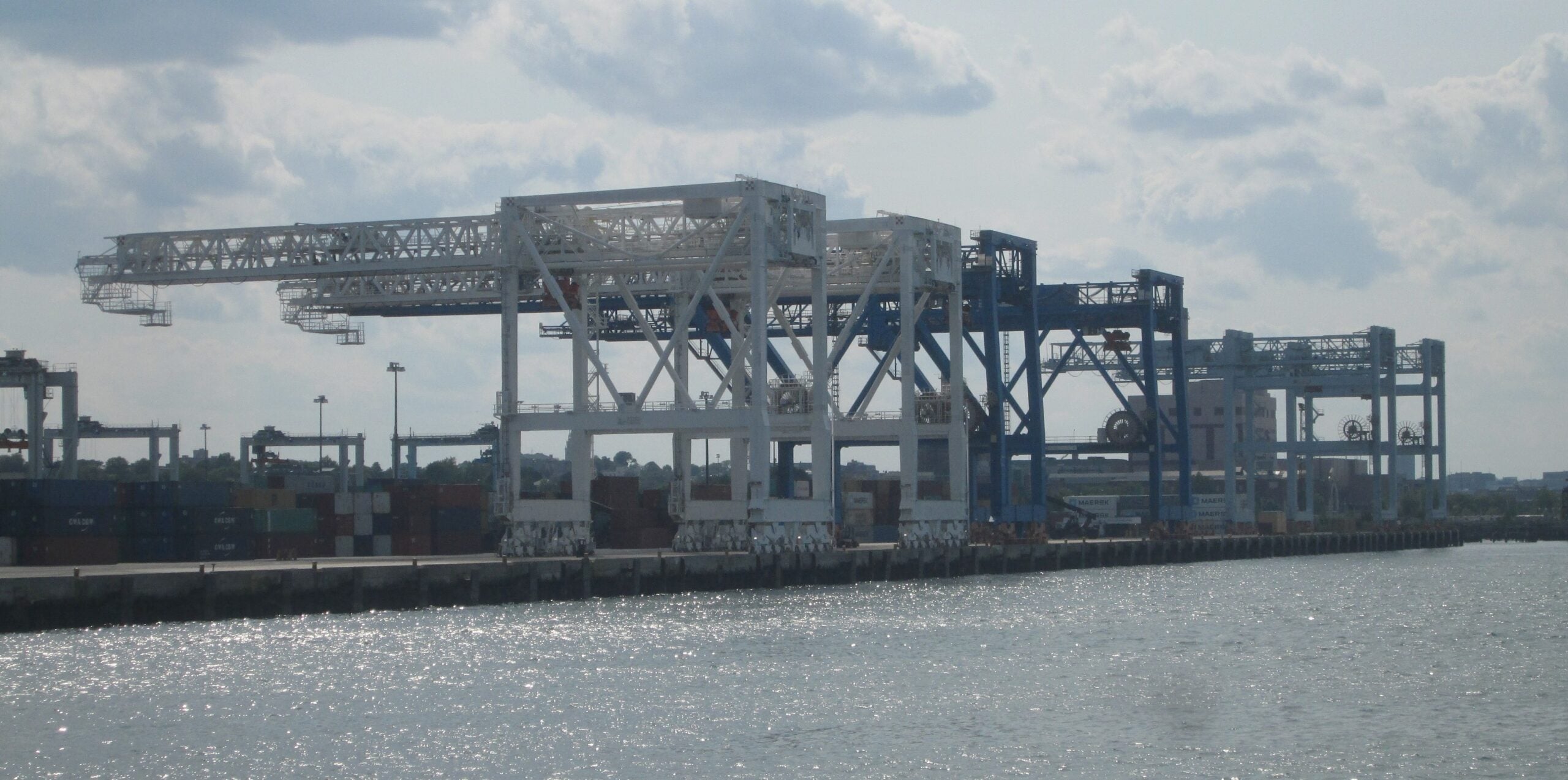 Gantry cranes and stacked containers at a port terminal