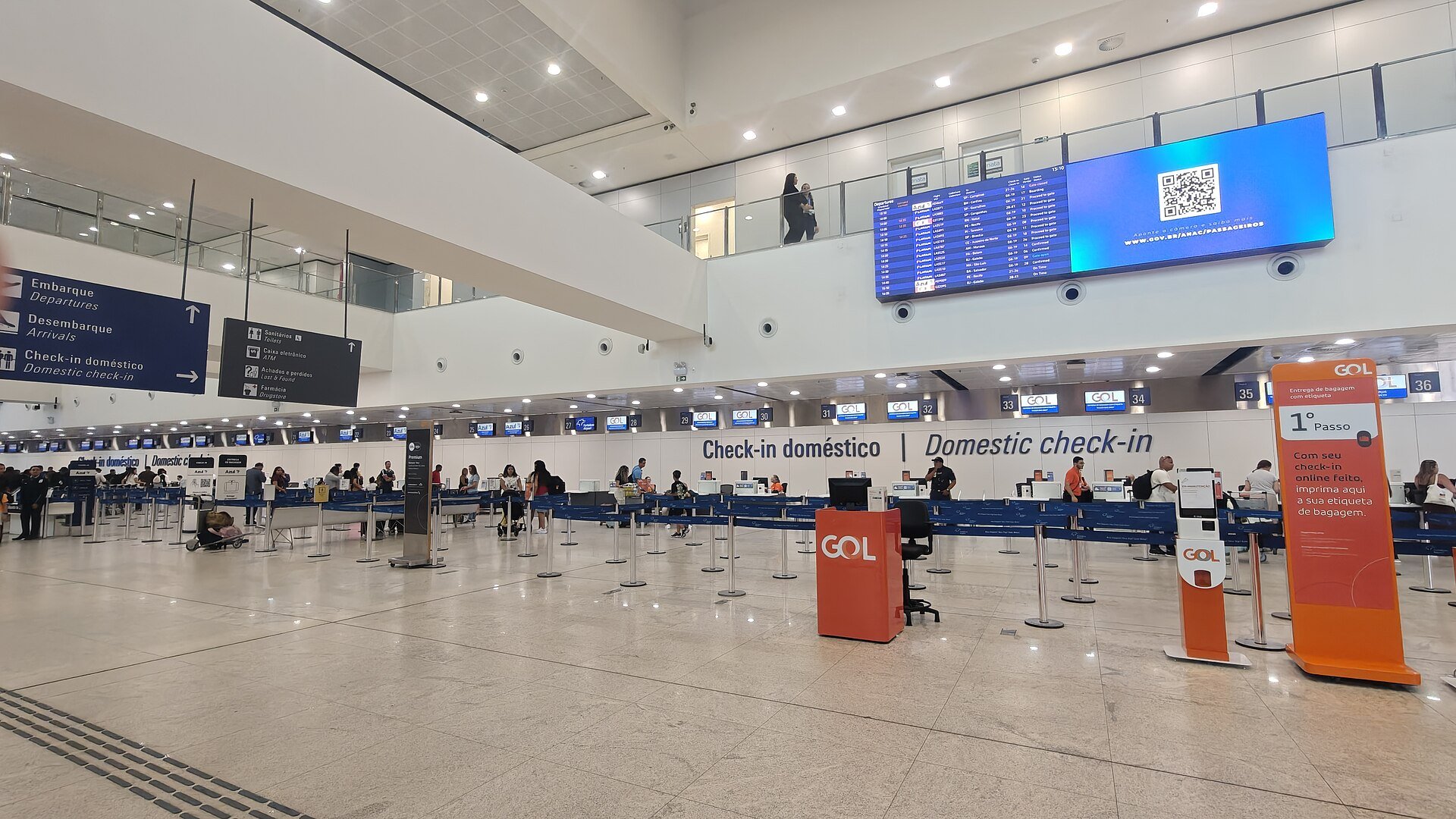 CVC travel context - departures hall at a Brazilian airport with travellers heading to check-in
