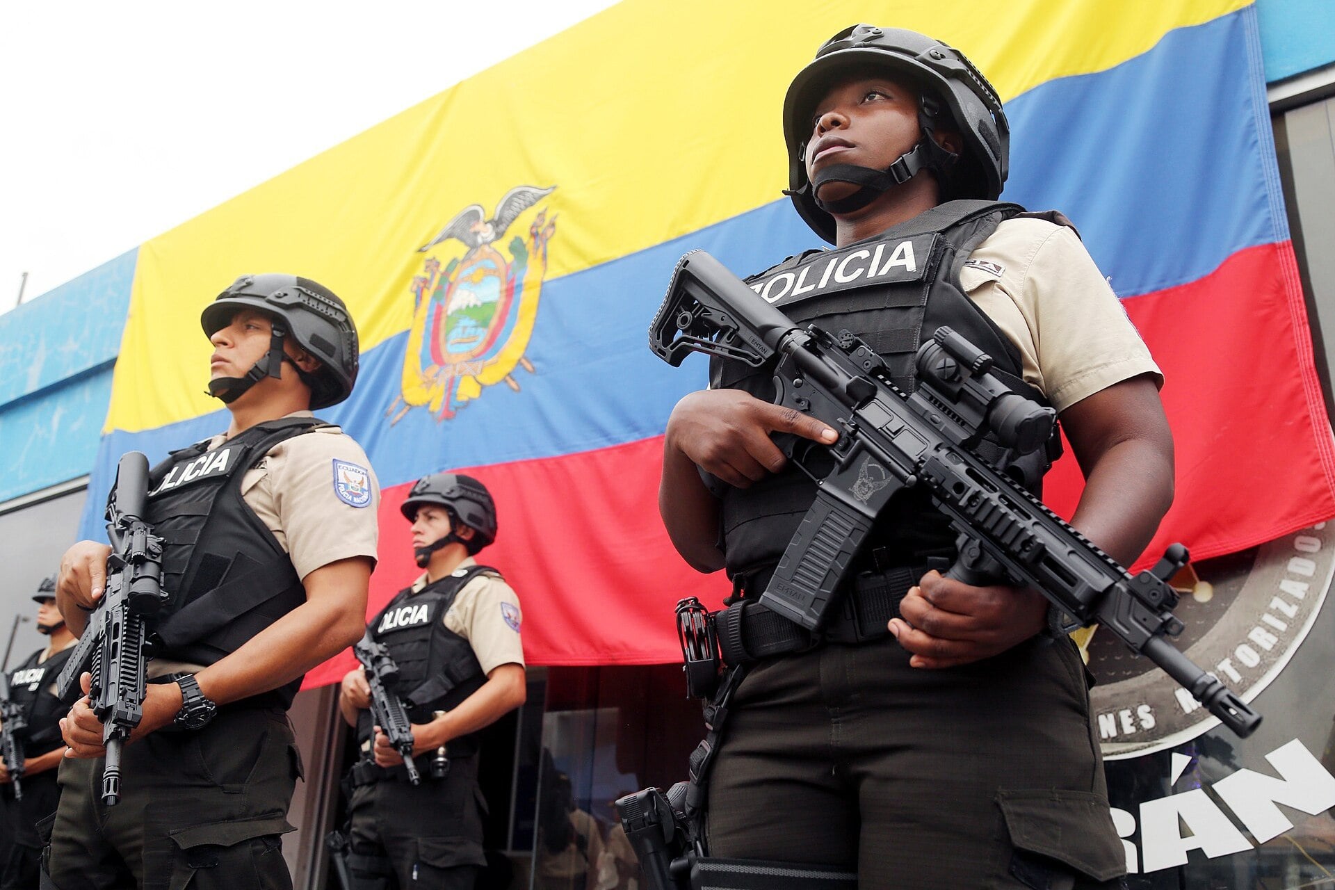 Ecuador cocaine seizure - National Police officers standing in front of the Ecuadorean flag
