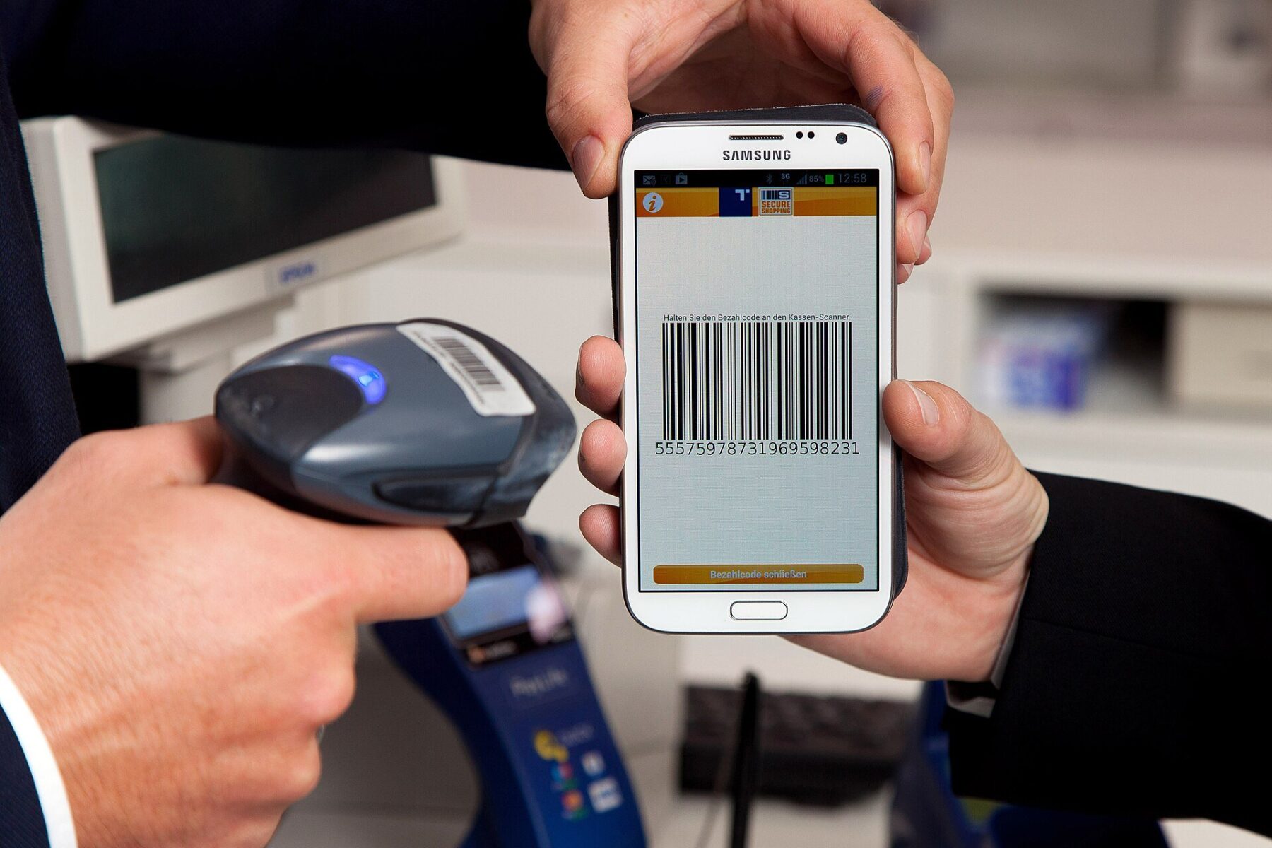 A customer paying with a smartphone banking app