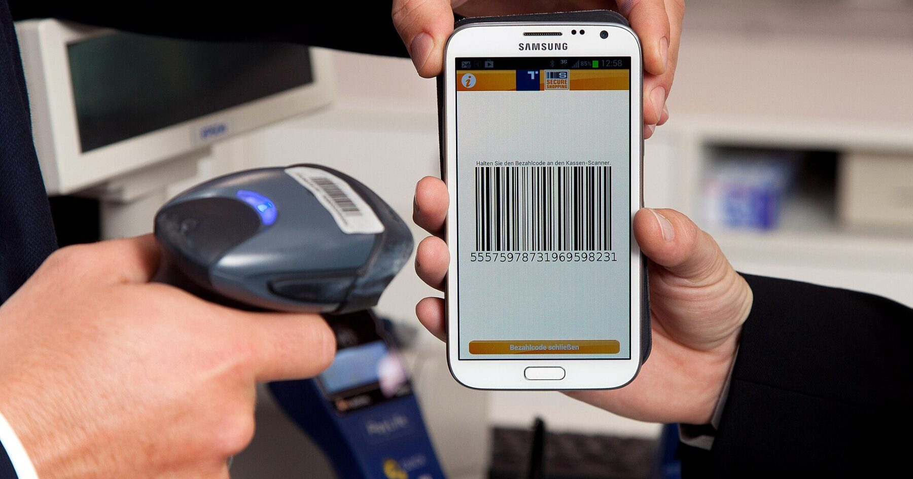 A customer paying with a smartphone banking app, illustrating Nubank's app-only model behind its record US$1 billion quarter.