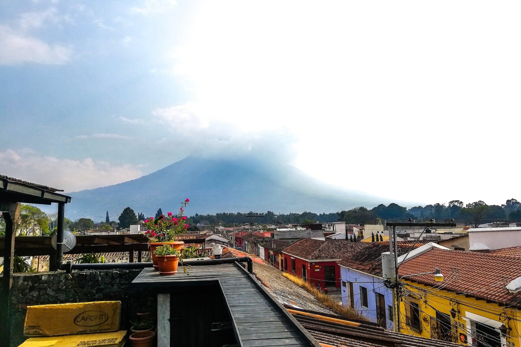 Rooftops of Antigua Guatemala with a volcano behind
