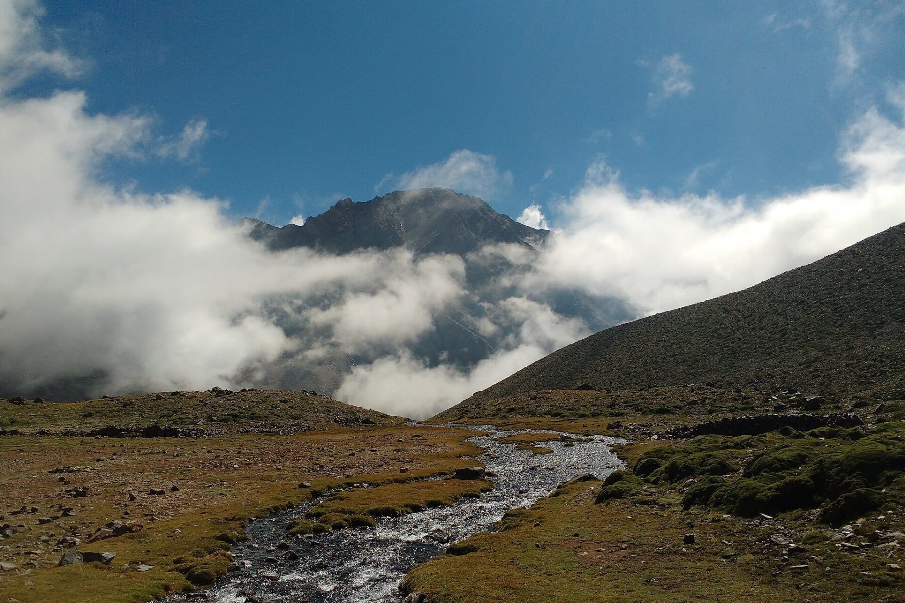 A cloud-wreathed peak in the Cordillera de los Andes, illustrating the closed Cristo Redentor pass between Mendoza and Santiago.