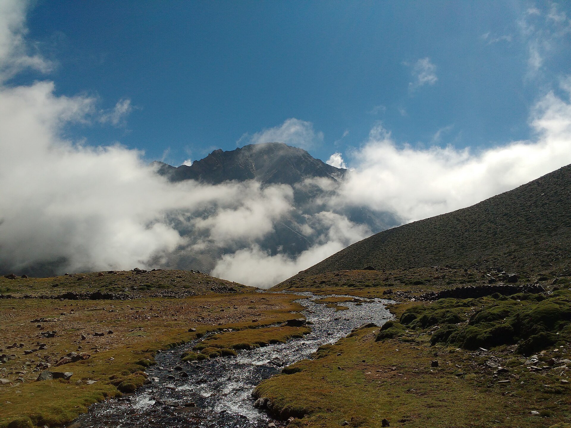 A cloud-wreathed peak in the Cordillera de los Andes, illustrating the closed Cristo Redentor pass between Mendoza and Santiago.