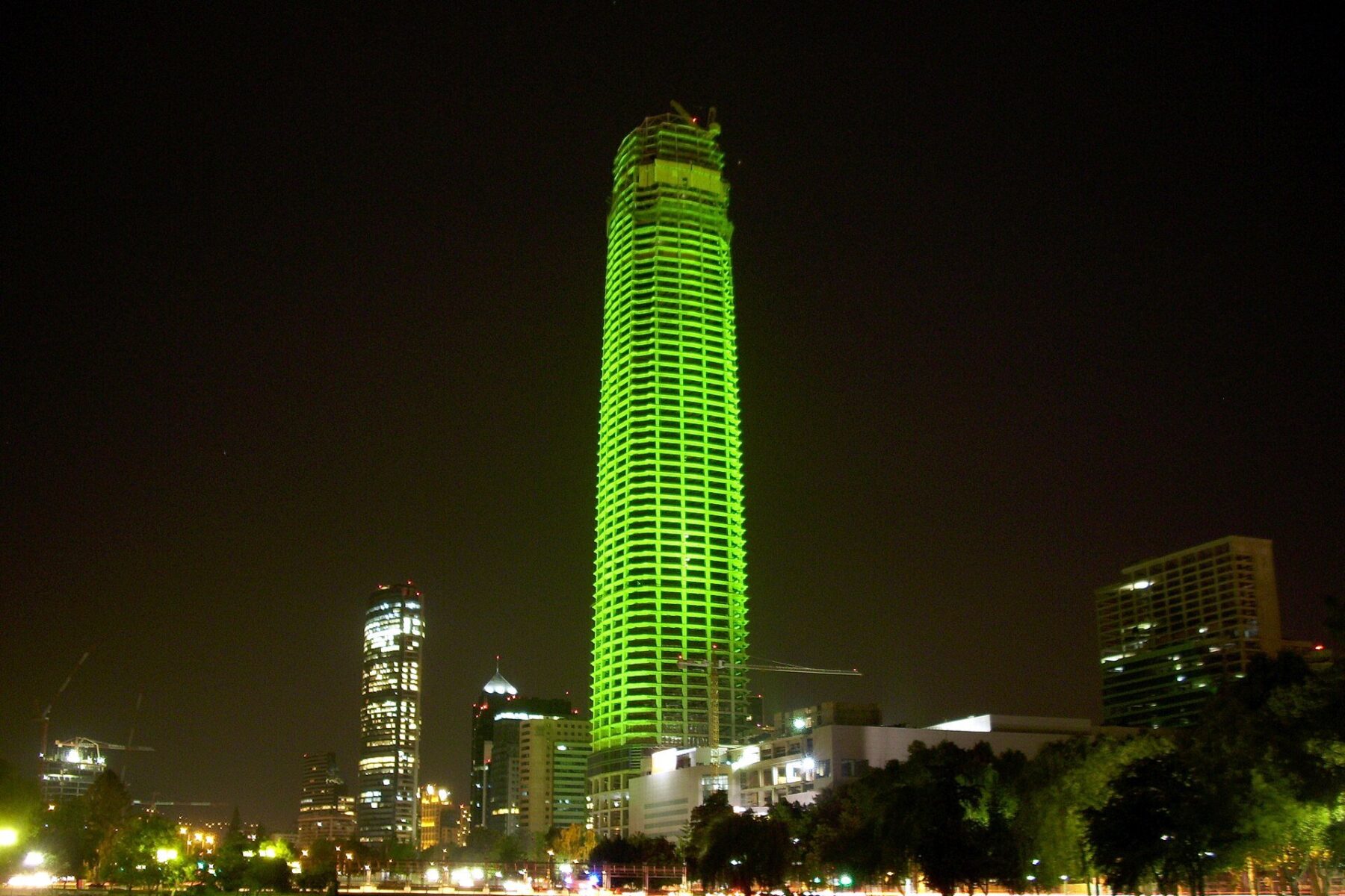 Santiago's financial-district skyline at night, the backdrop to Chile tax reform news that gives new-home buyers a value-added tax break.