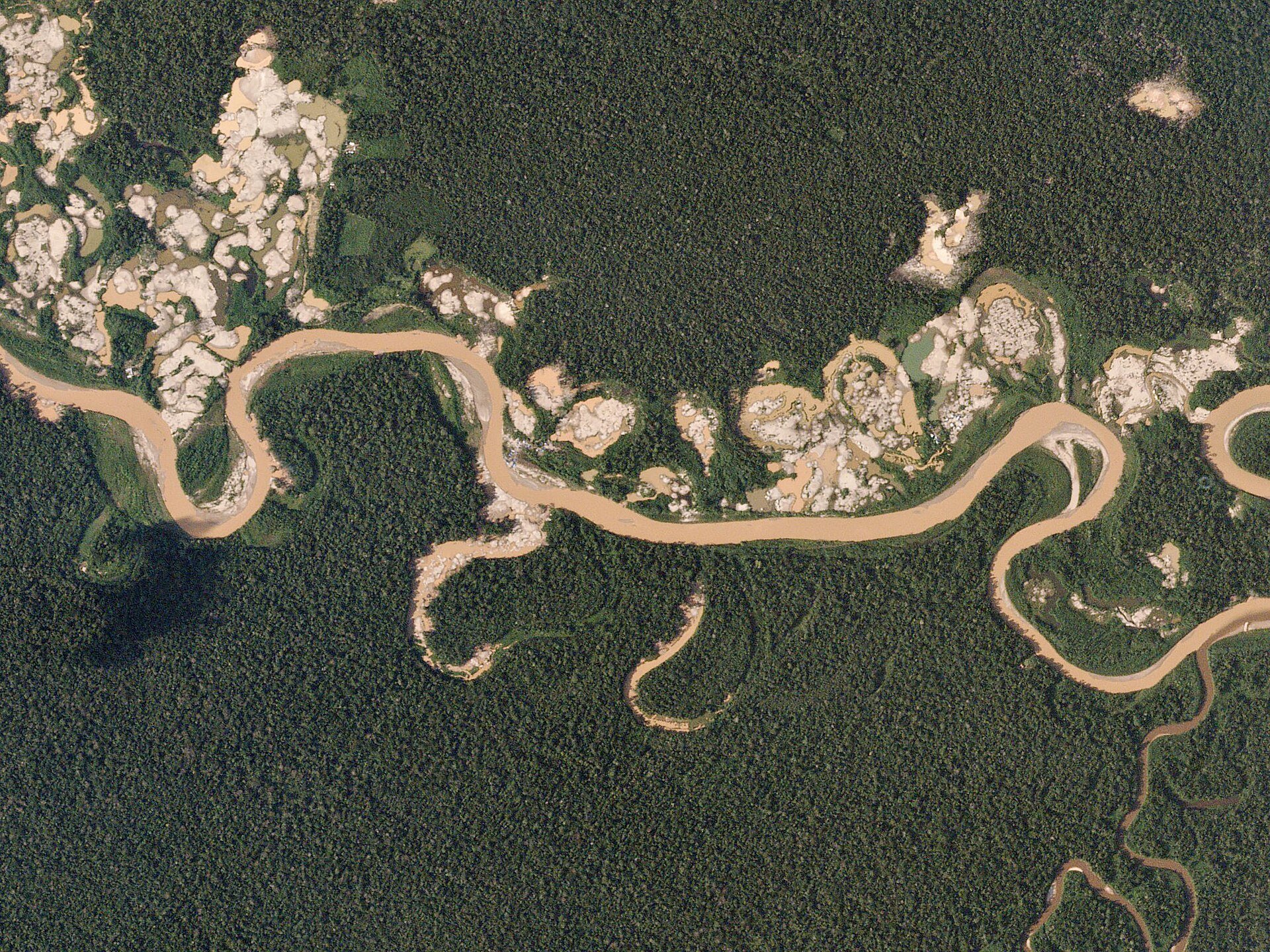 Ecuador illegal mining - aerial view of gold-mining scars along an Amazon river