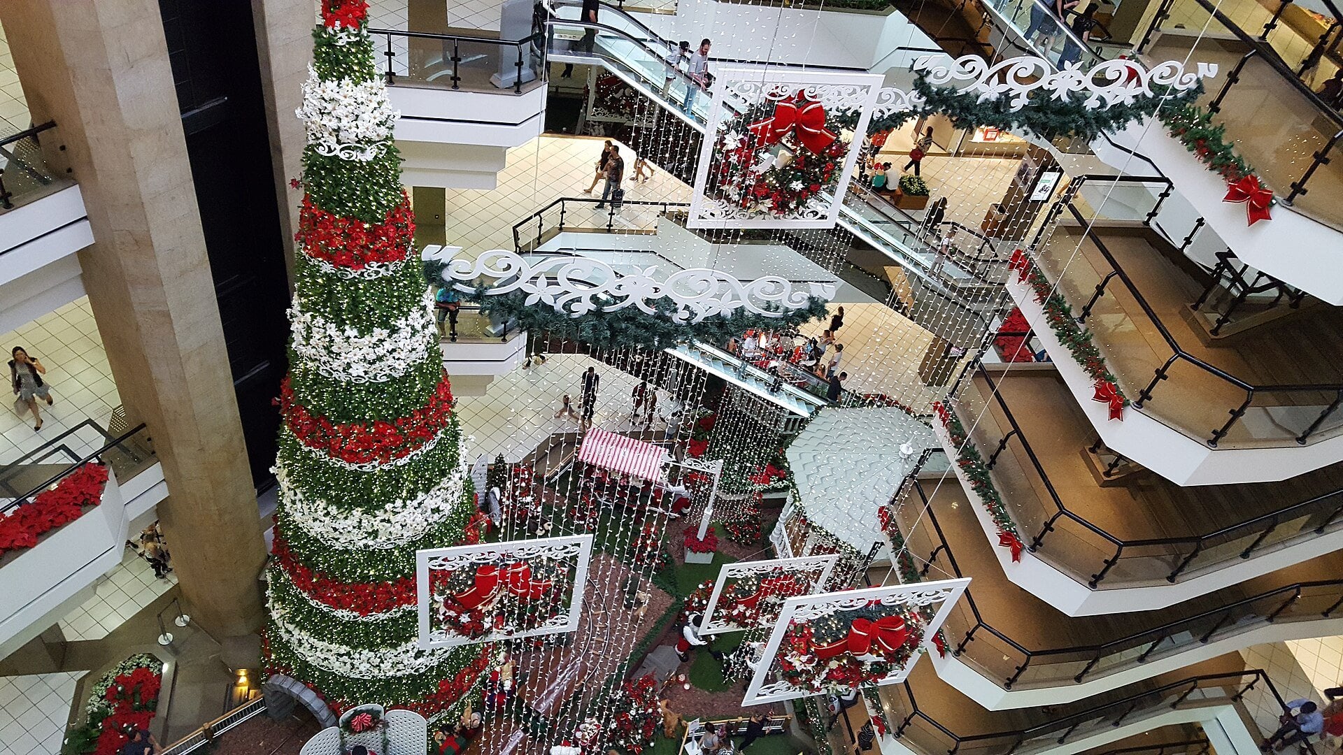 Allos - interior of a busy shopping mall with stores and shoppers