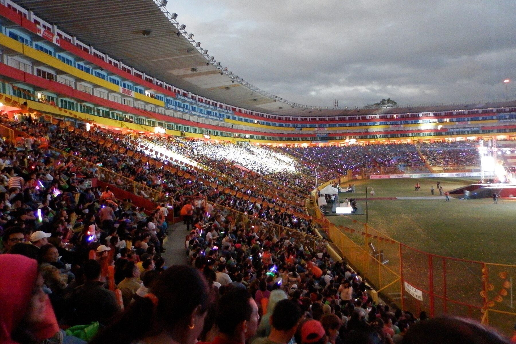 Milo J - concert crowd under the lights at a stadium in San Salvador, El Salvador