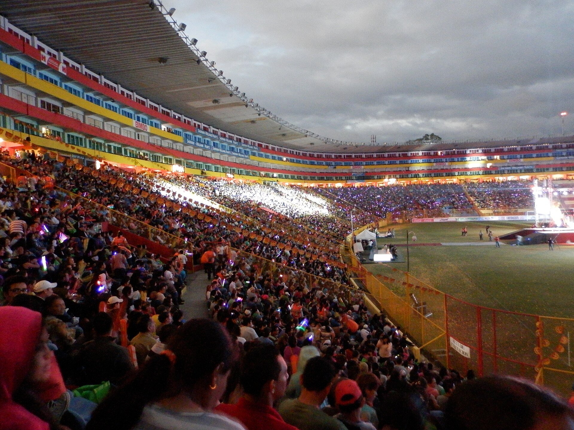 Milo J - concert crowd under the lights at a stadium in San Salvador, El Salvador