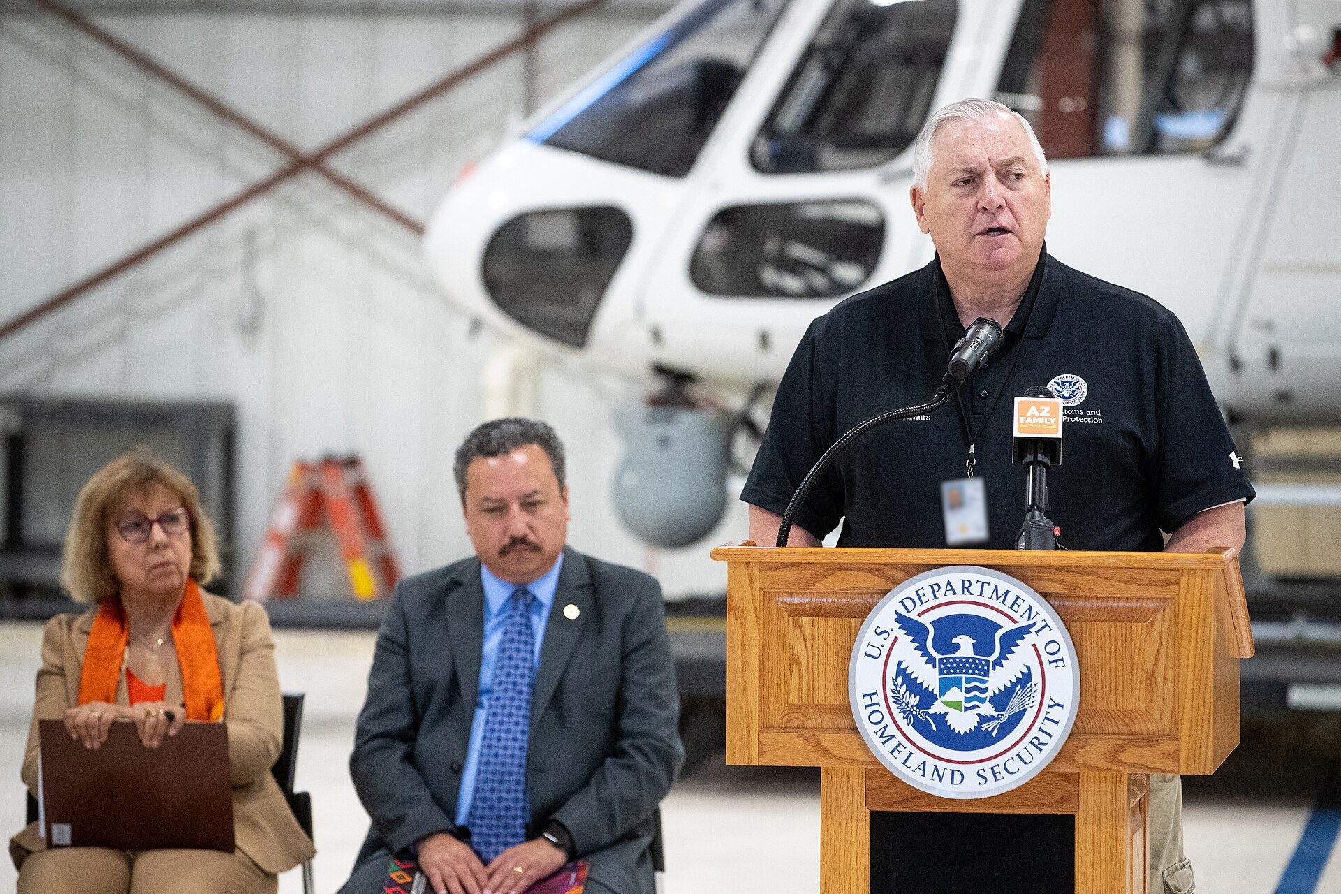 Mexico deportations - migrants and border officials at a US-Mexico border event