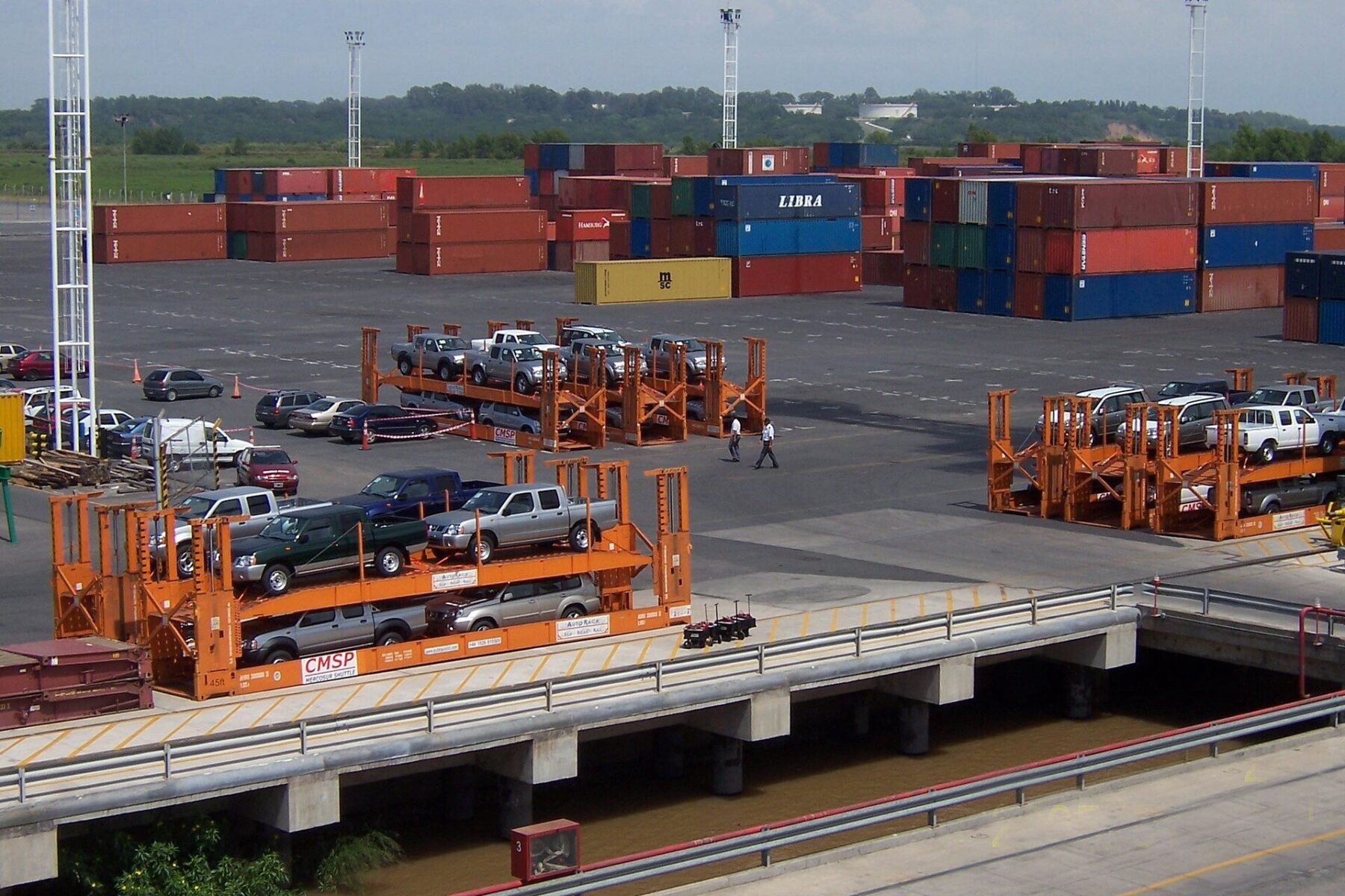 Argentina imports - shipping containers and imported vehicles stacked at a container port terminal