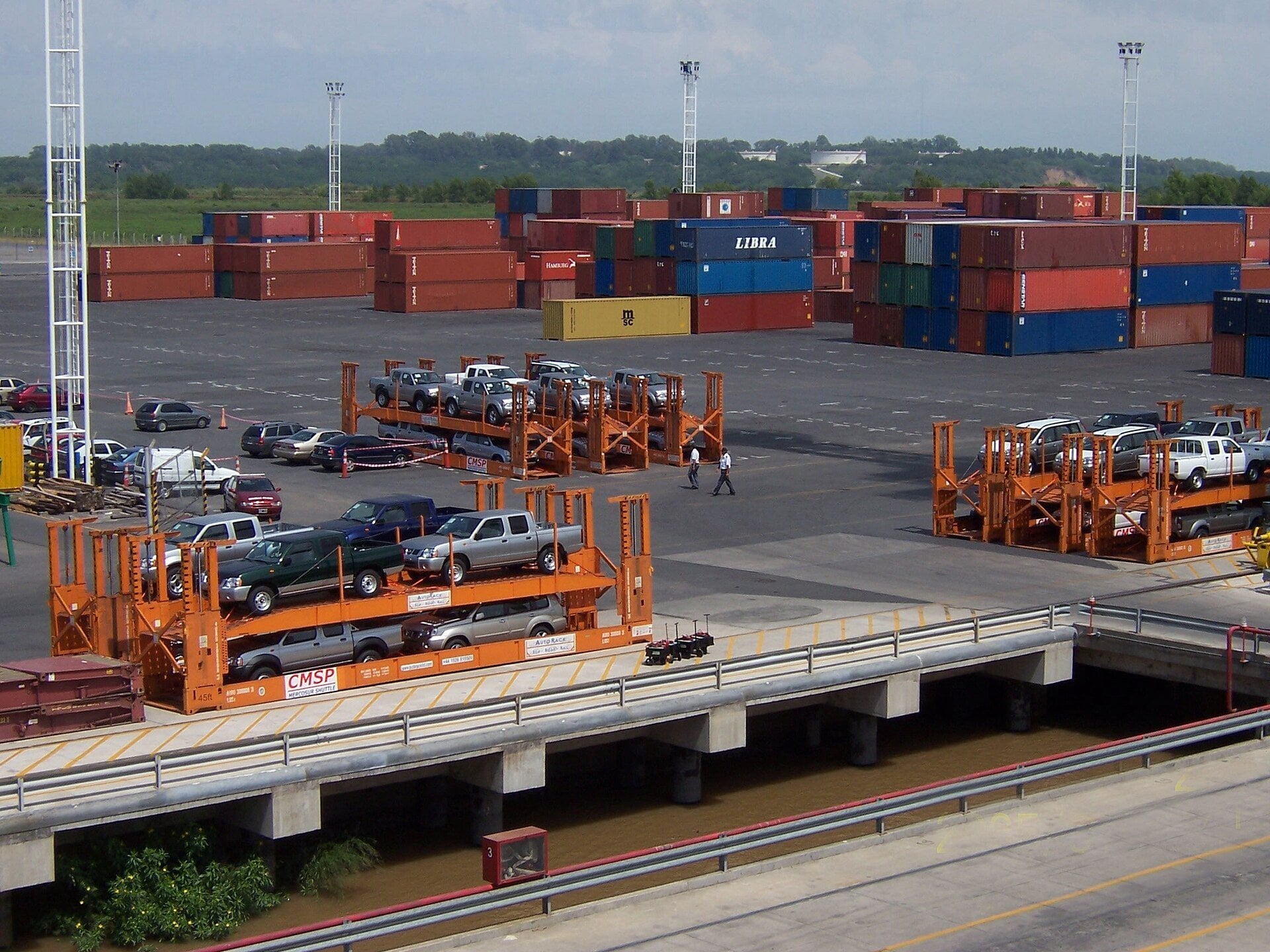 Argentina imports - shipping containers and imported vehicles stacked at a container port terminal