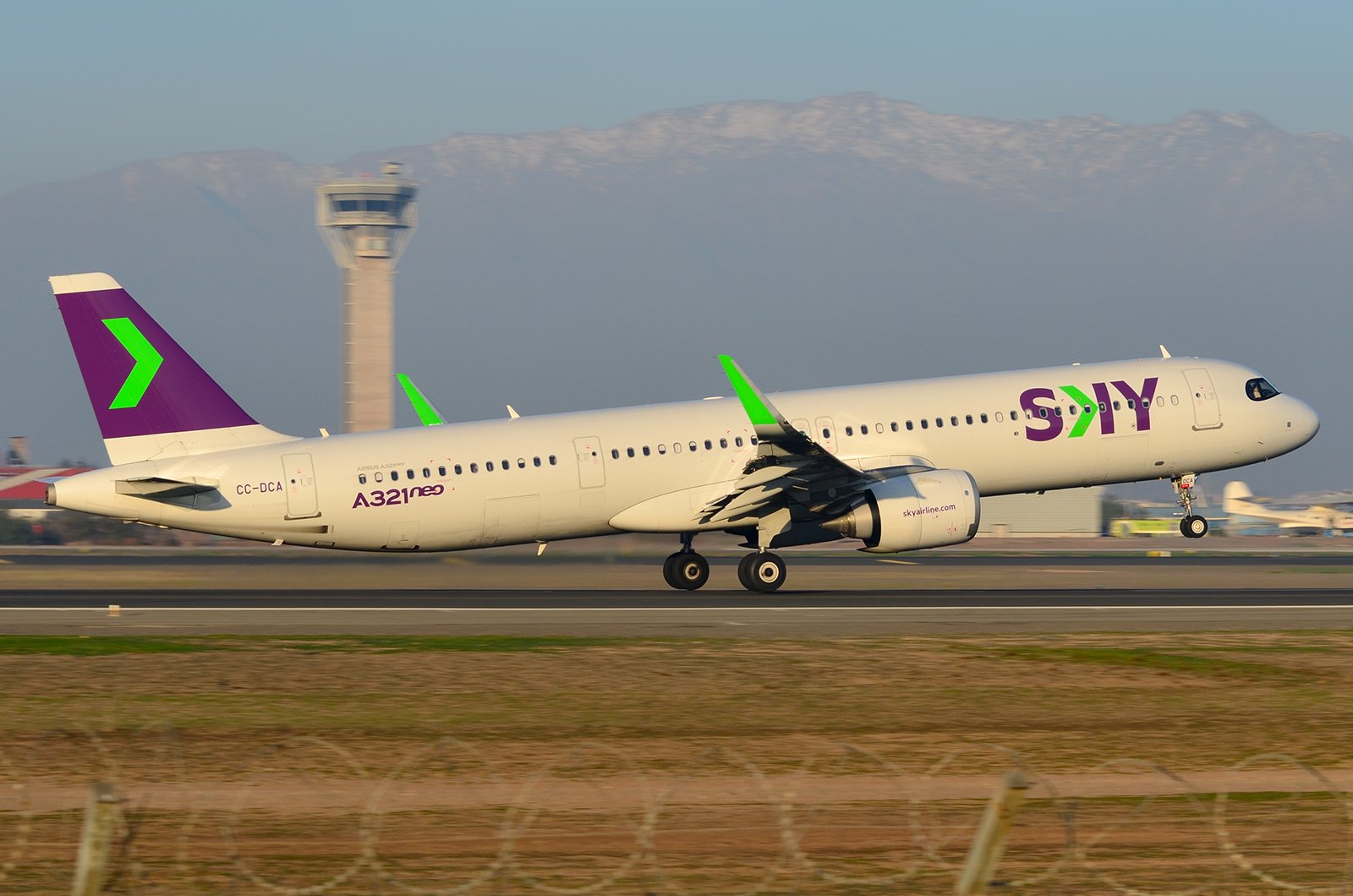 A SKY Airline aircraft at an airport, illustrating Abra Group's approved takeover of the Chilean low-cost carrier