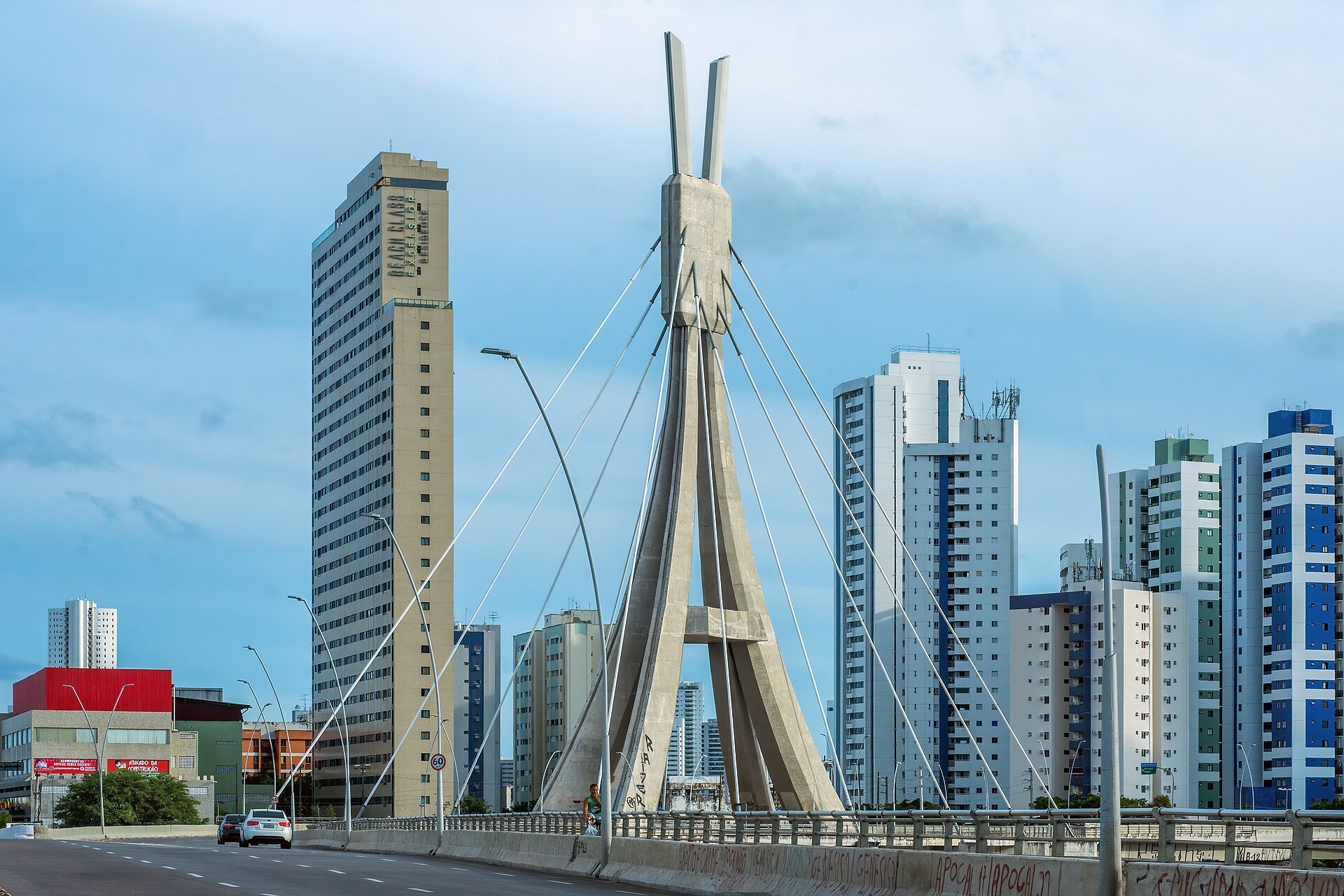 Moura Dubeux context - residential apartment towers and a cable-stayed bridge on the Recife skyline in Brazil's Northeast