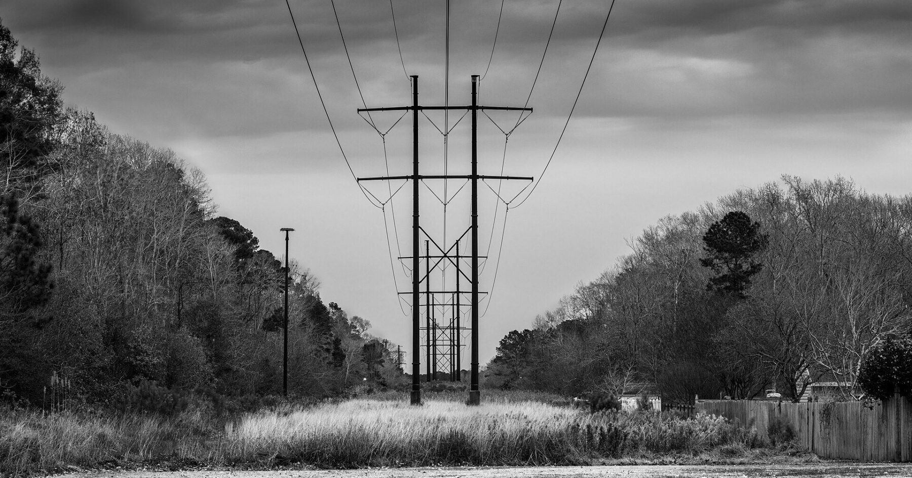 High-voltage power lines at dusk, illustrating Colombia's power and water recovery after the earthquake.