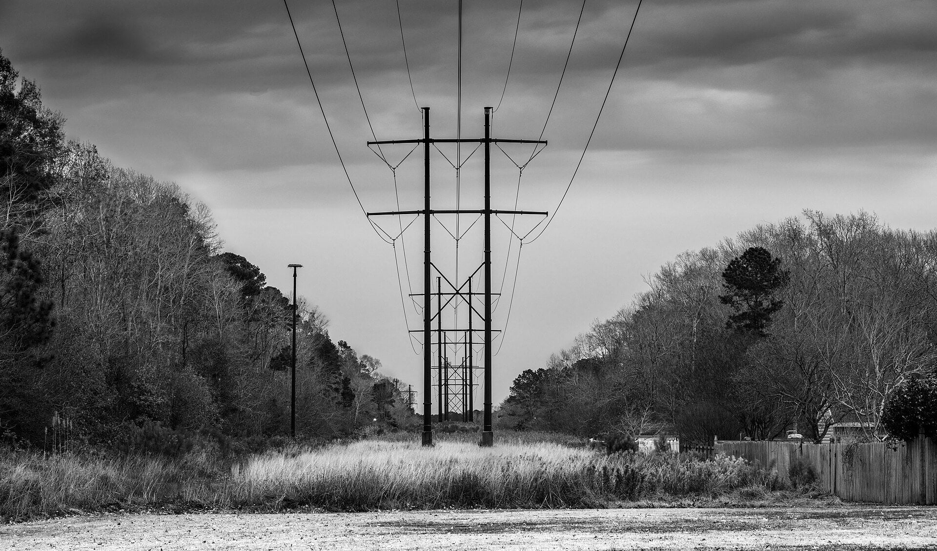 High-voltage power lines at dusk, illustrating Colombia's power and water recovery after the earthquake.