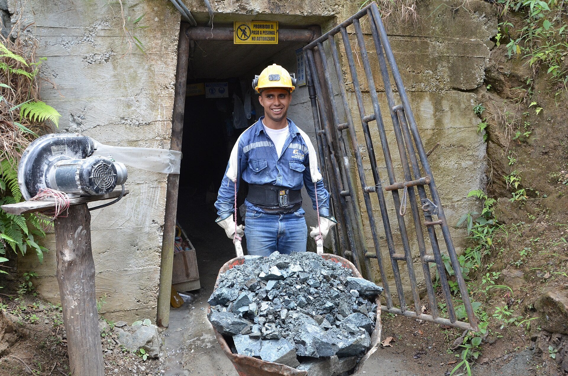 Colombia gold mine worker carrying ore out of a small-scale shaft in San Roque