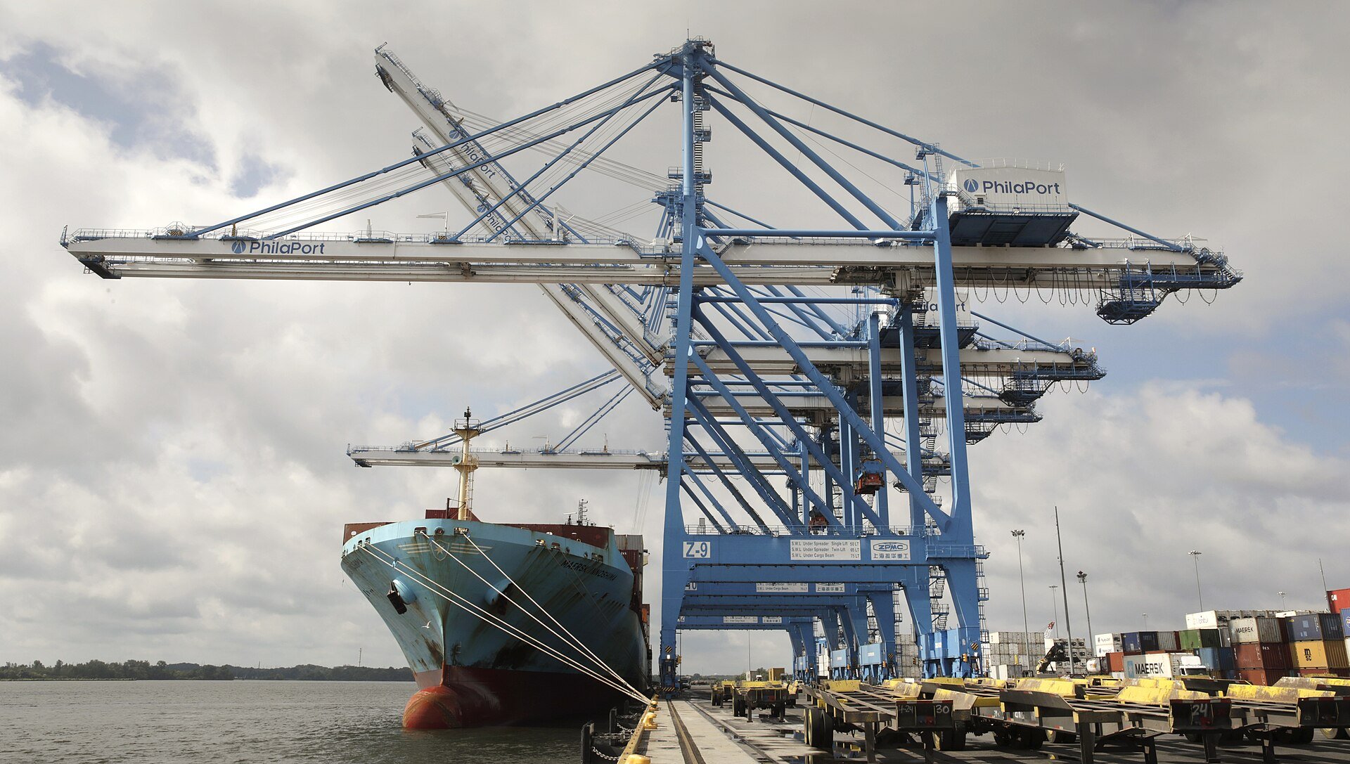 Container ship and port cranes at a marine terminal, illustrating CSN infrastructure and logistics assets