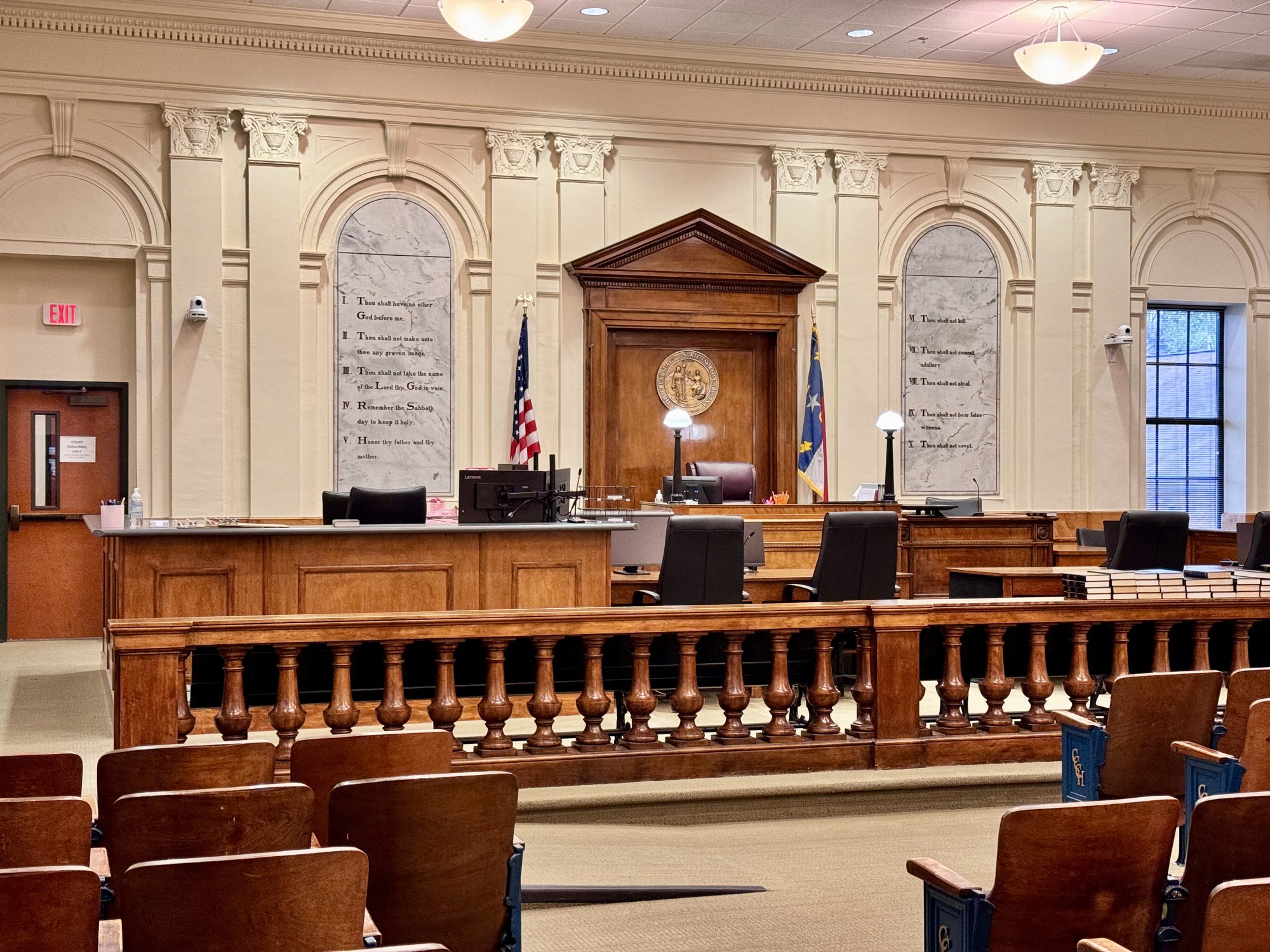 judicial pay top-ups — an empty courtroom with bench and seats