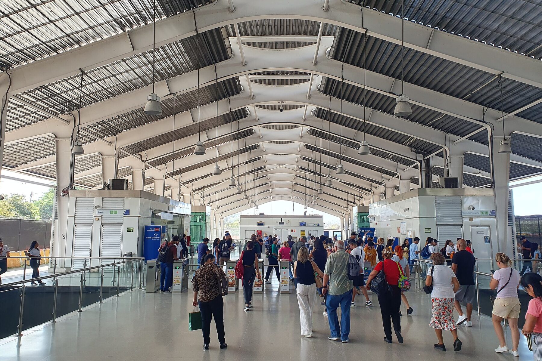 Passengers walking through the fare gates in the concourse of Albrook metro station in Panama City