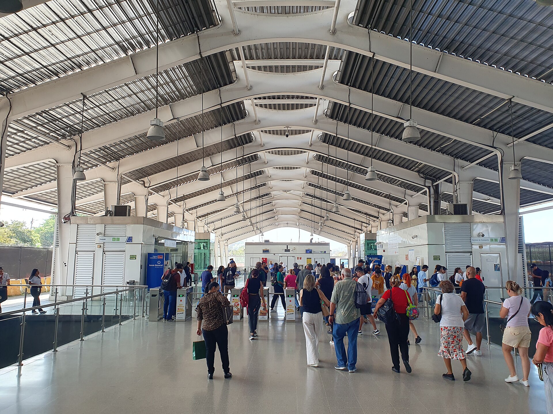 Passengers walking through the fare gates at Albrook metro station in Panama City