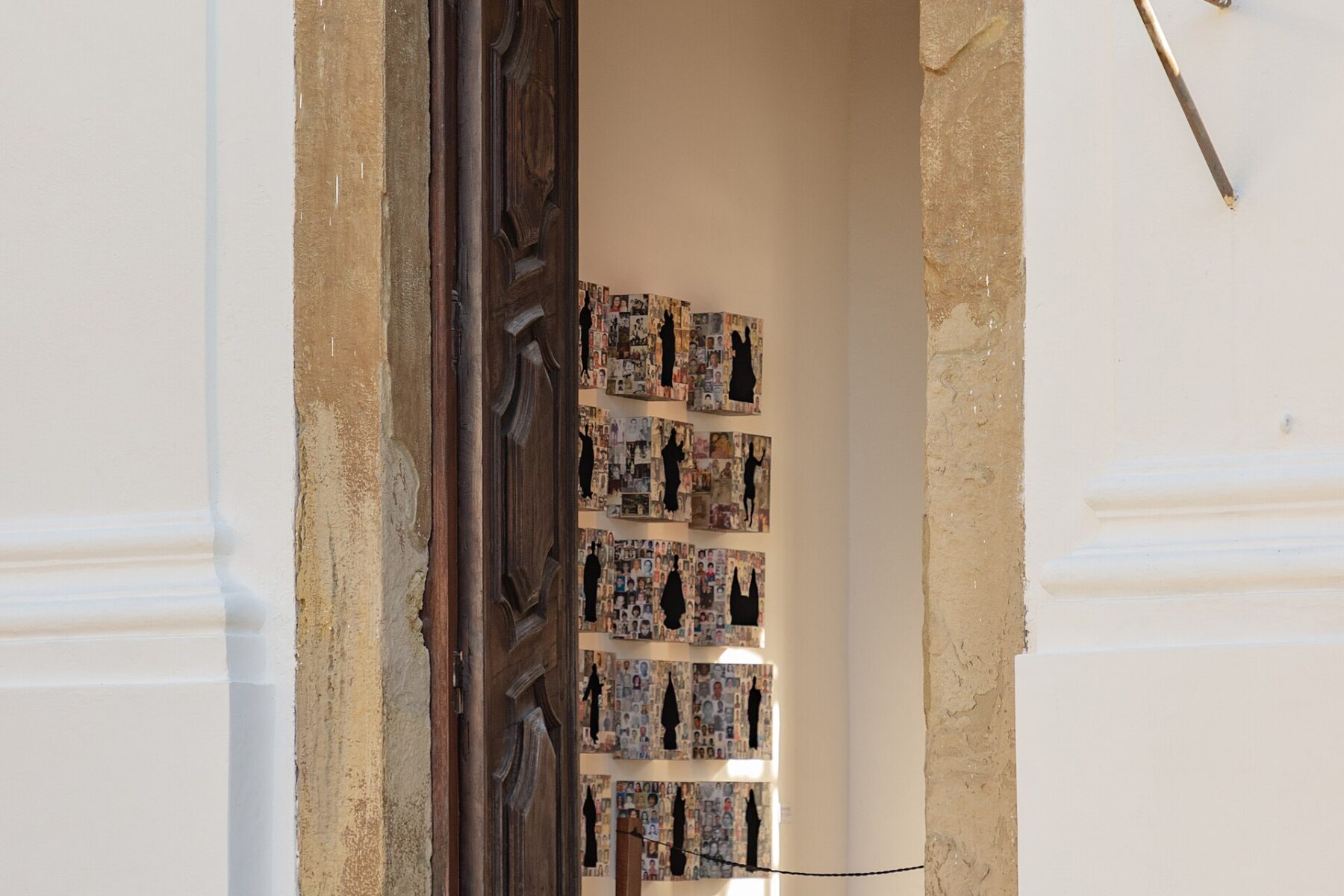 Art installation visible through an arched doorway