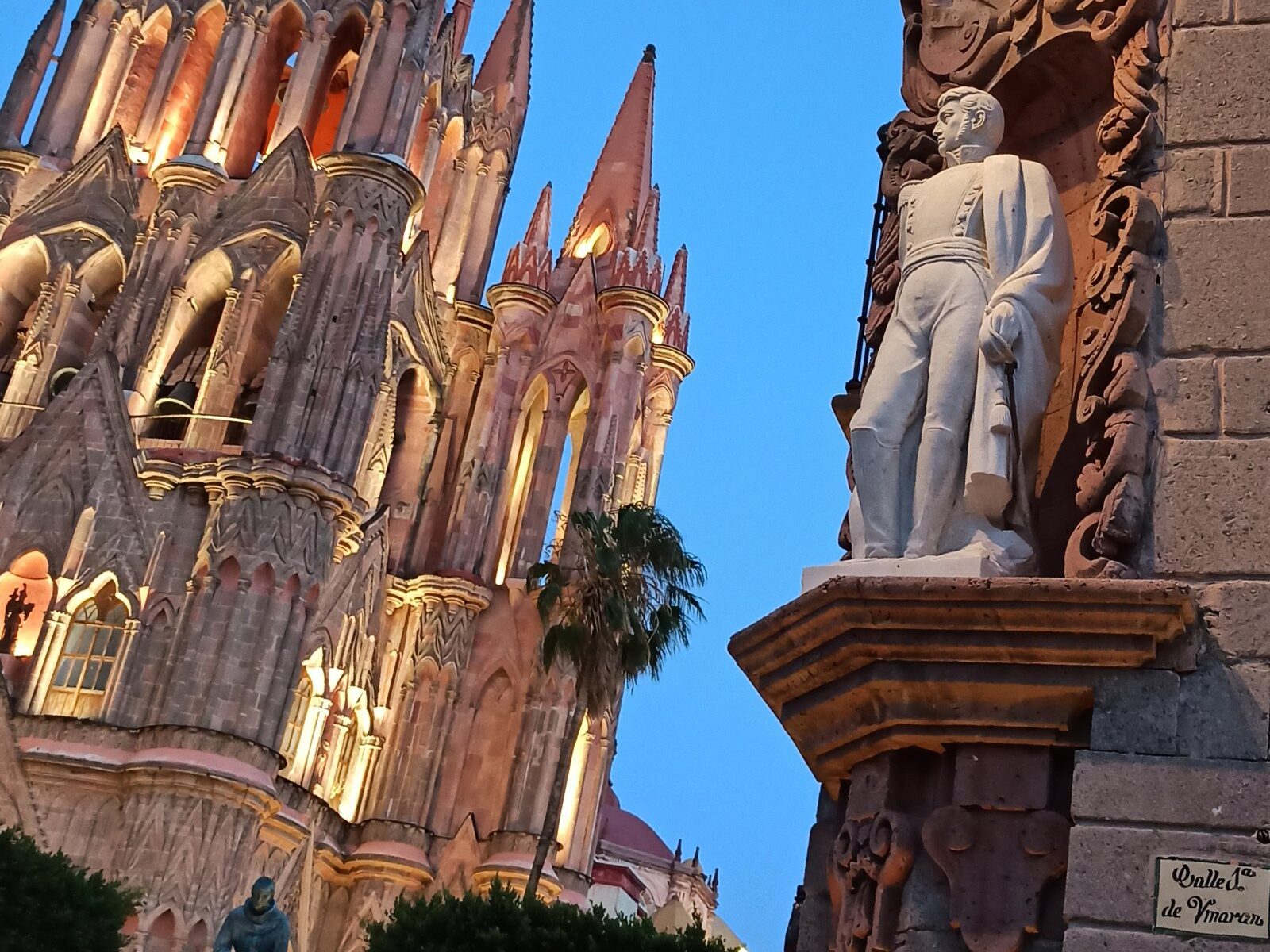 San Miguel de Allende guide: vineyard rows with blue mountains, a colonial bell tower, and a wine glass in the foreground