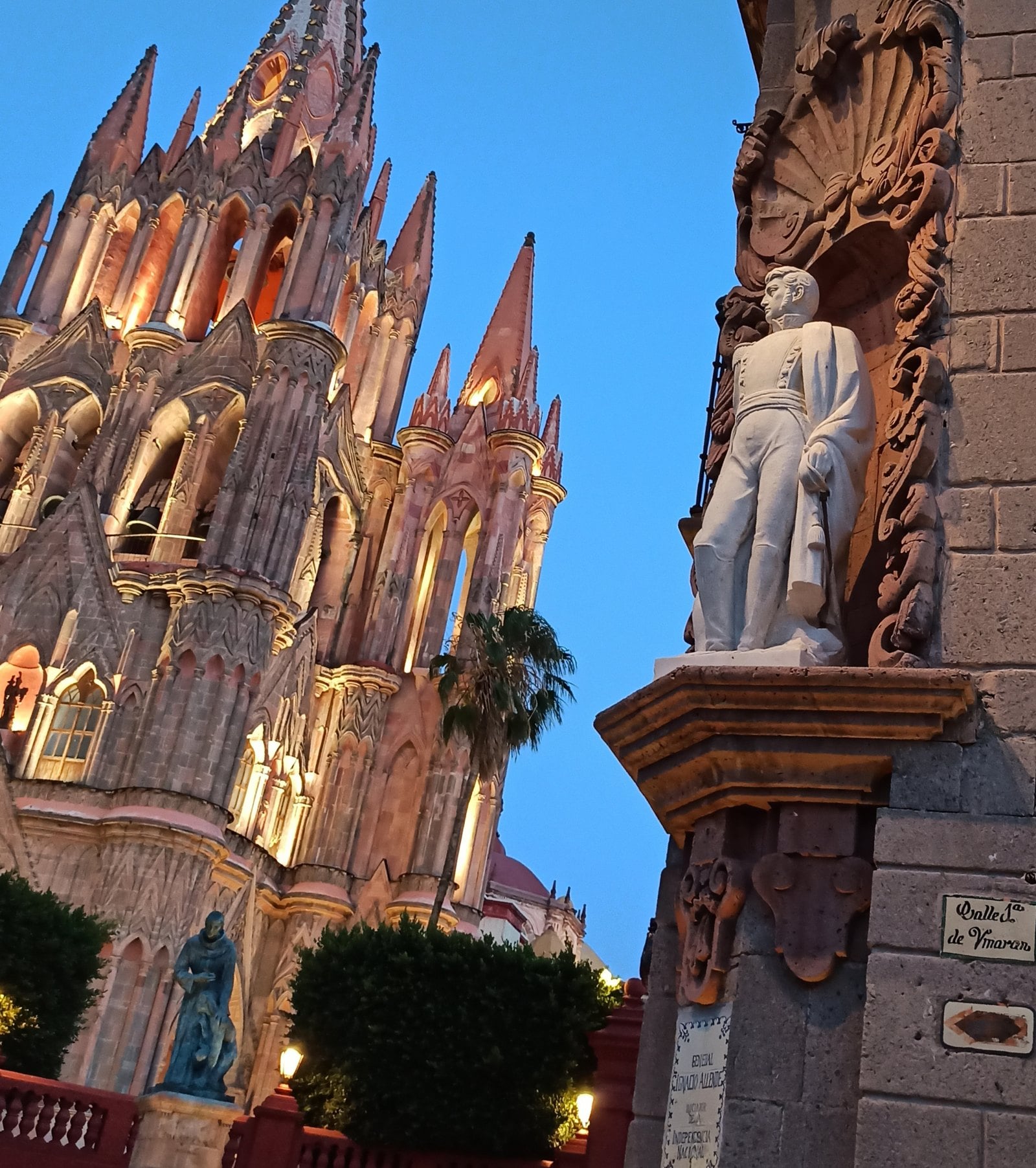 San Miguel de Allende guide: vineyard rows with blue mountains, a colonial bell tower, and a wine glass in the foreground