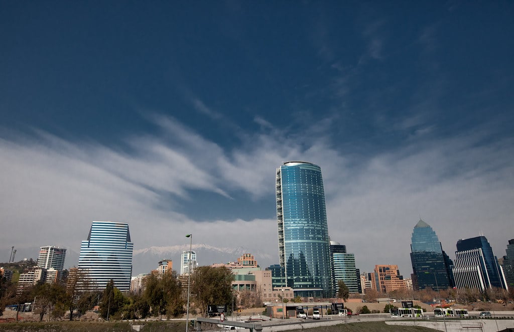 Santiago's financial district towers with the Andes mountains behind.
