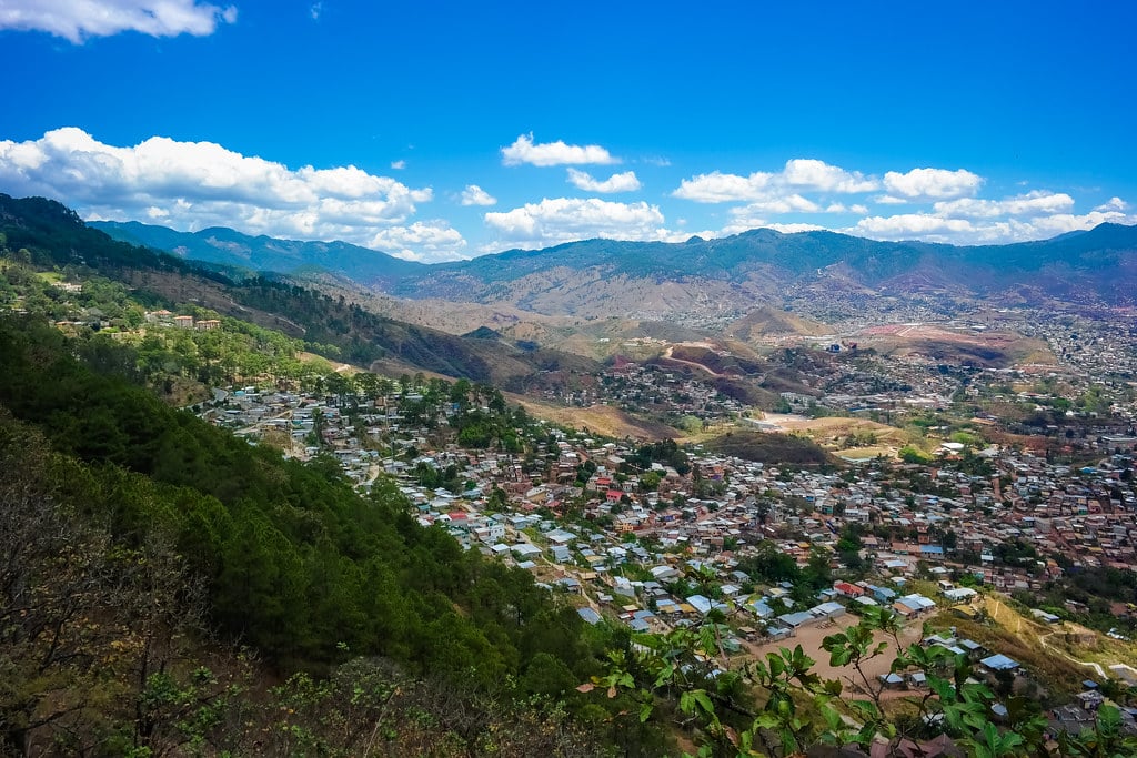 Tegucigalpa spread across its valley, hillside housing and mountains under a blue sky