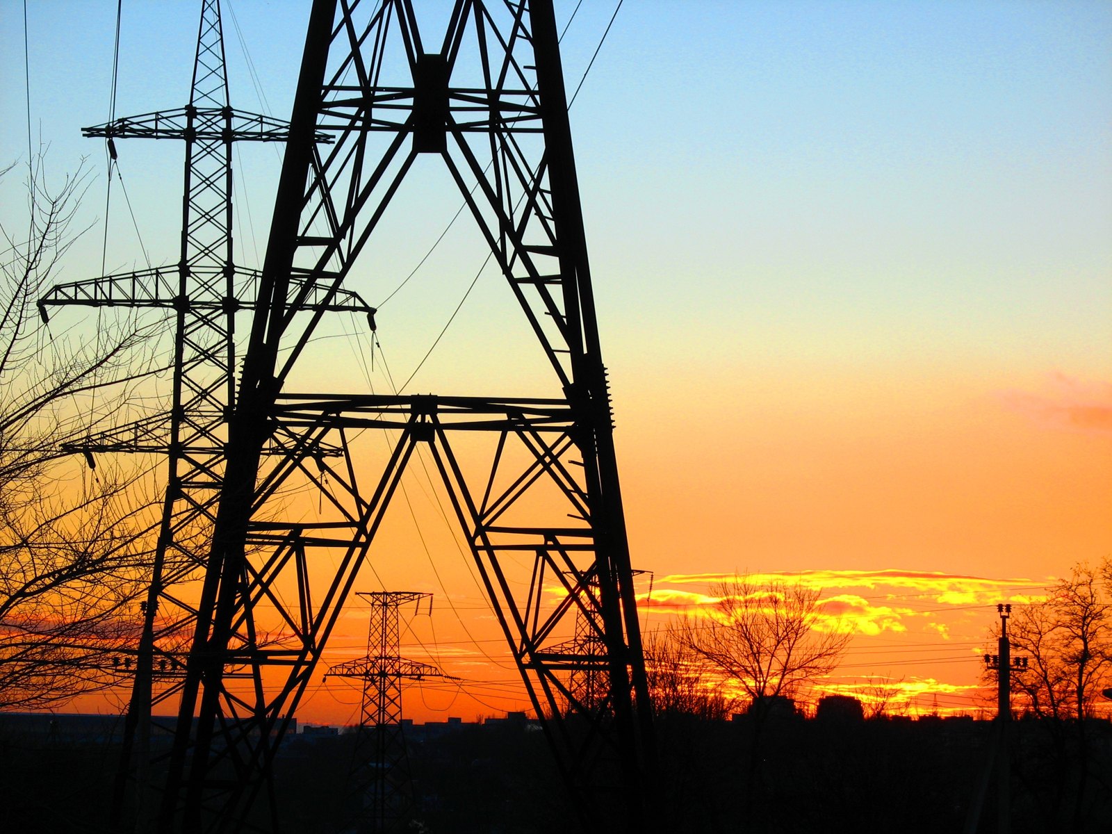 High-voltage power lines at sunset.