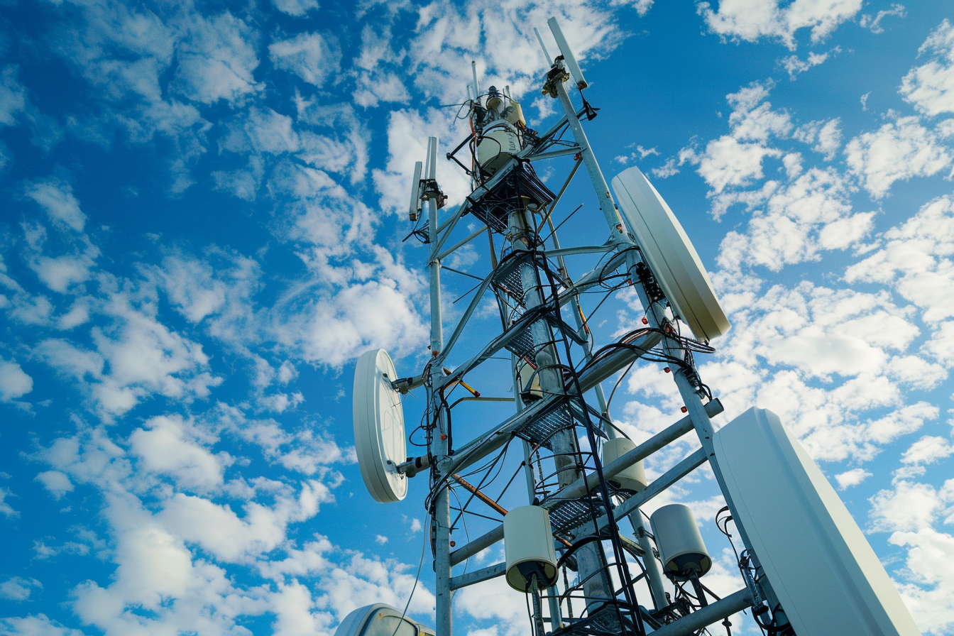A mobile network antenna tower at sunset