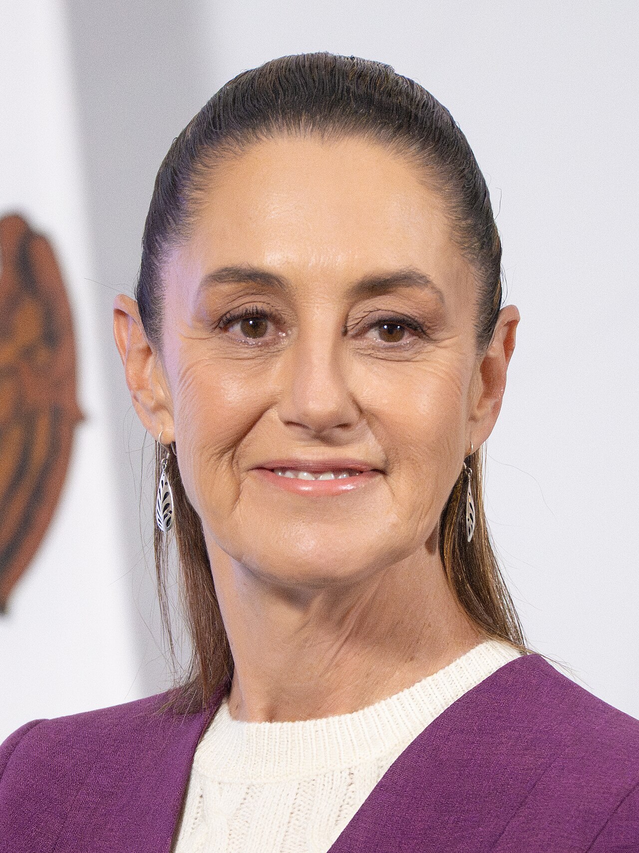 Mexican President Claudia Sheinbaum speaking at a podium during her second annual state-of-the-government address in Mexico City