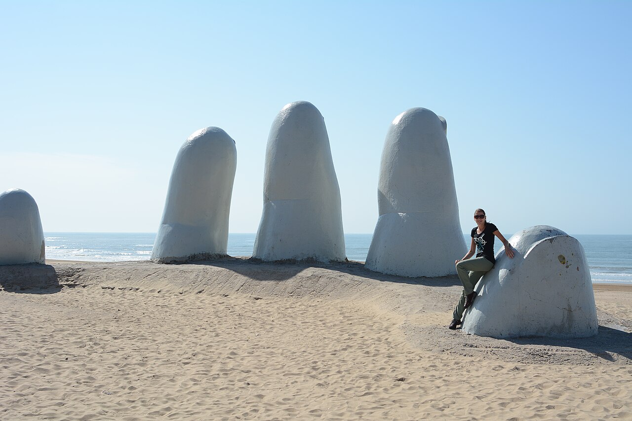 The white fingers of the Los Dedos sculpture rising from the sand at Punta del Este