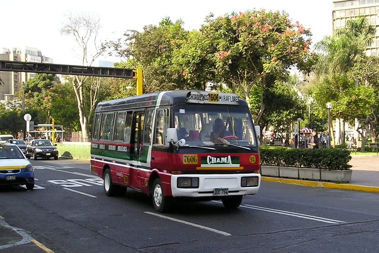 A public transit bus on a city street in Callao, Peru, next to Lima