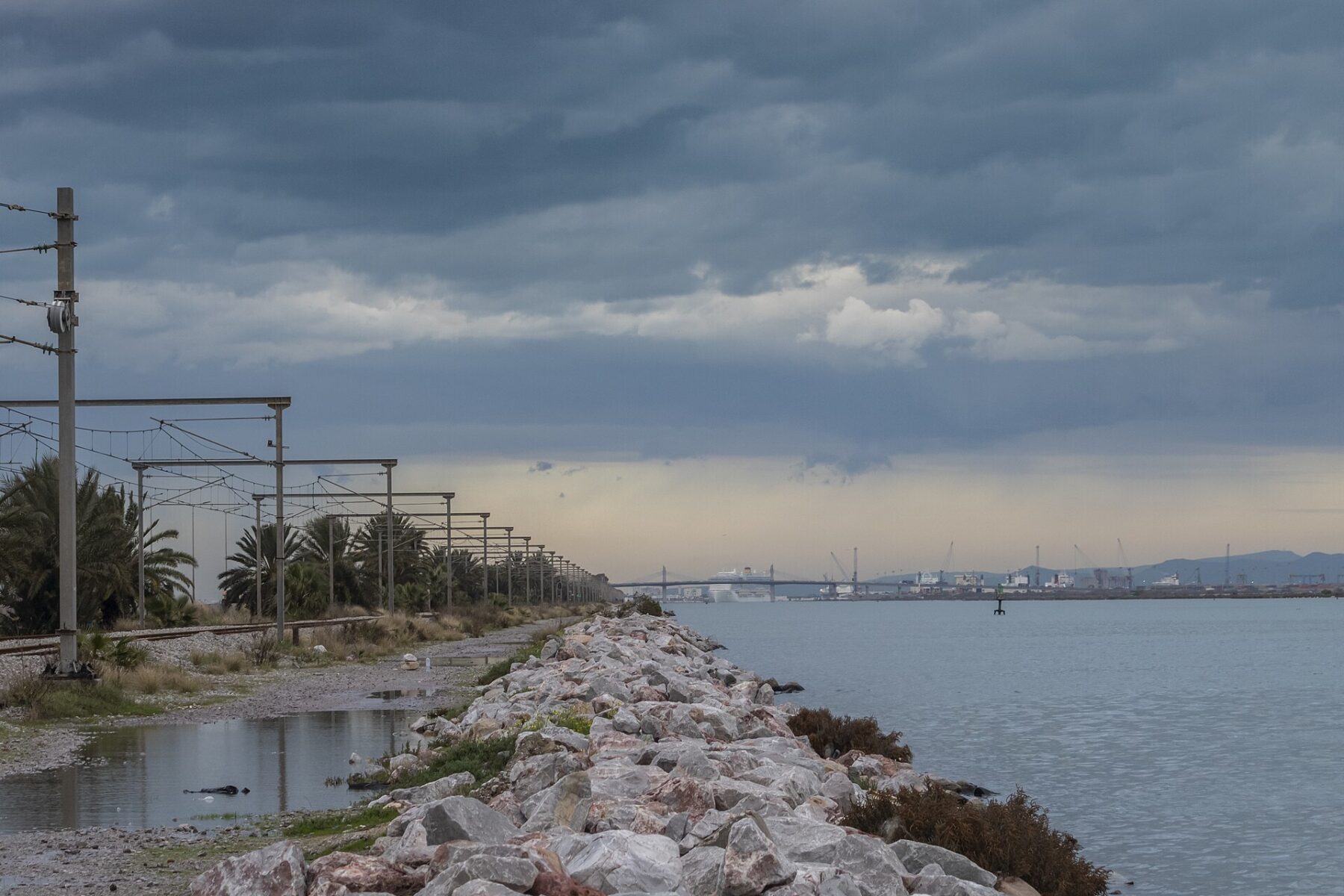 Shoreline and port near Tunis under a cloudy sky