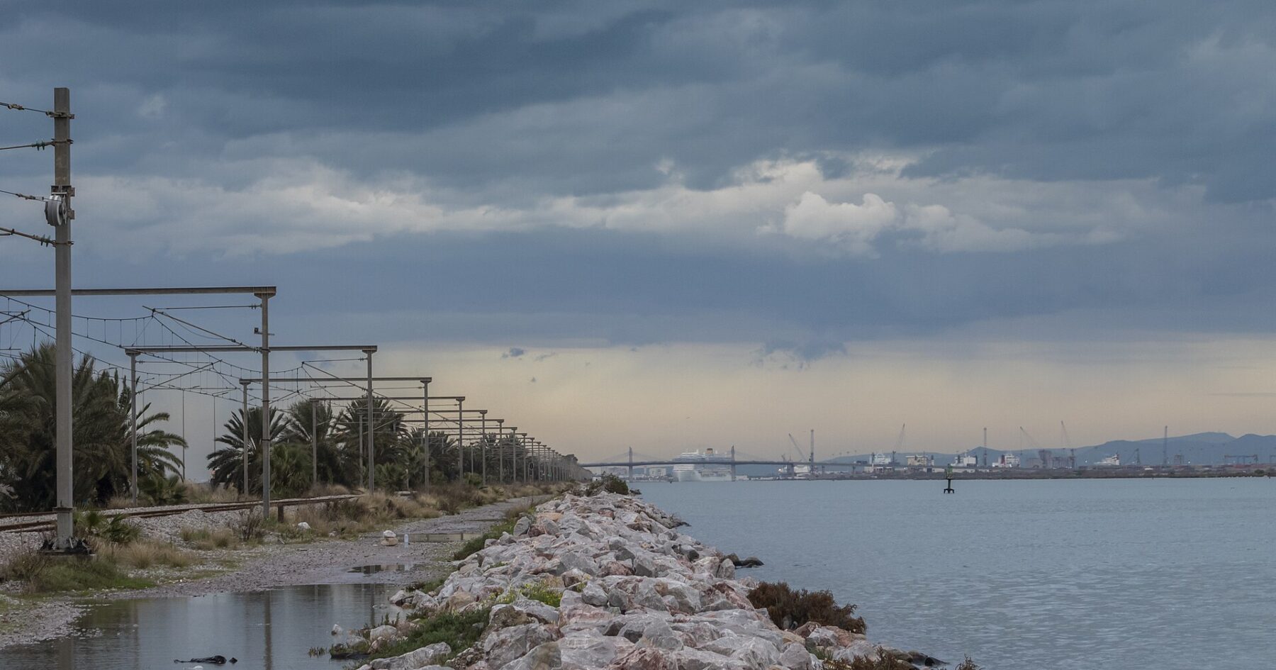Shoreline and port near Tunis under a cloudy sky